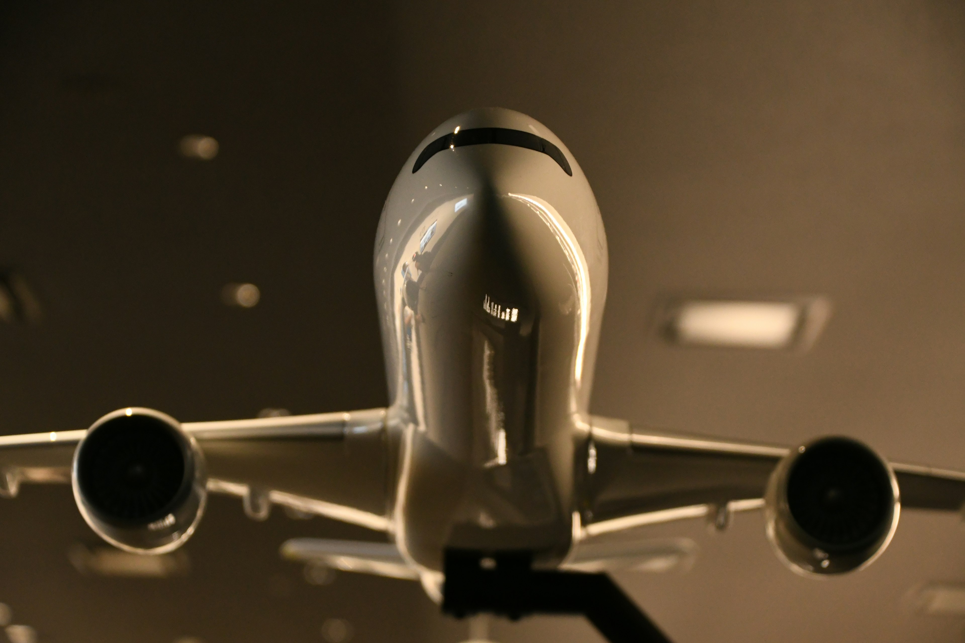 Model airplane viewed from the front with a bright background highlighting its design