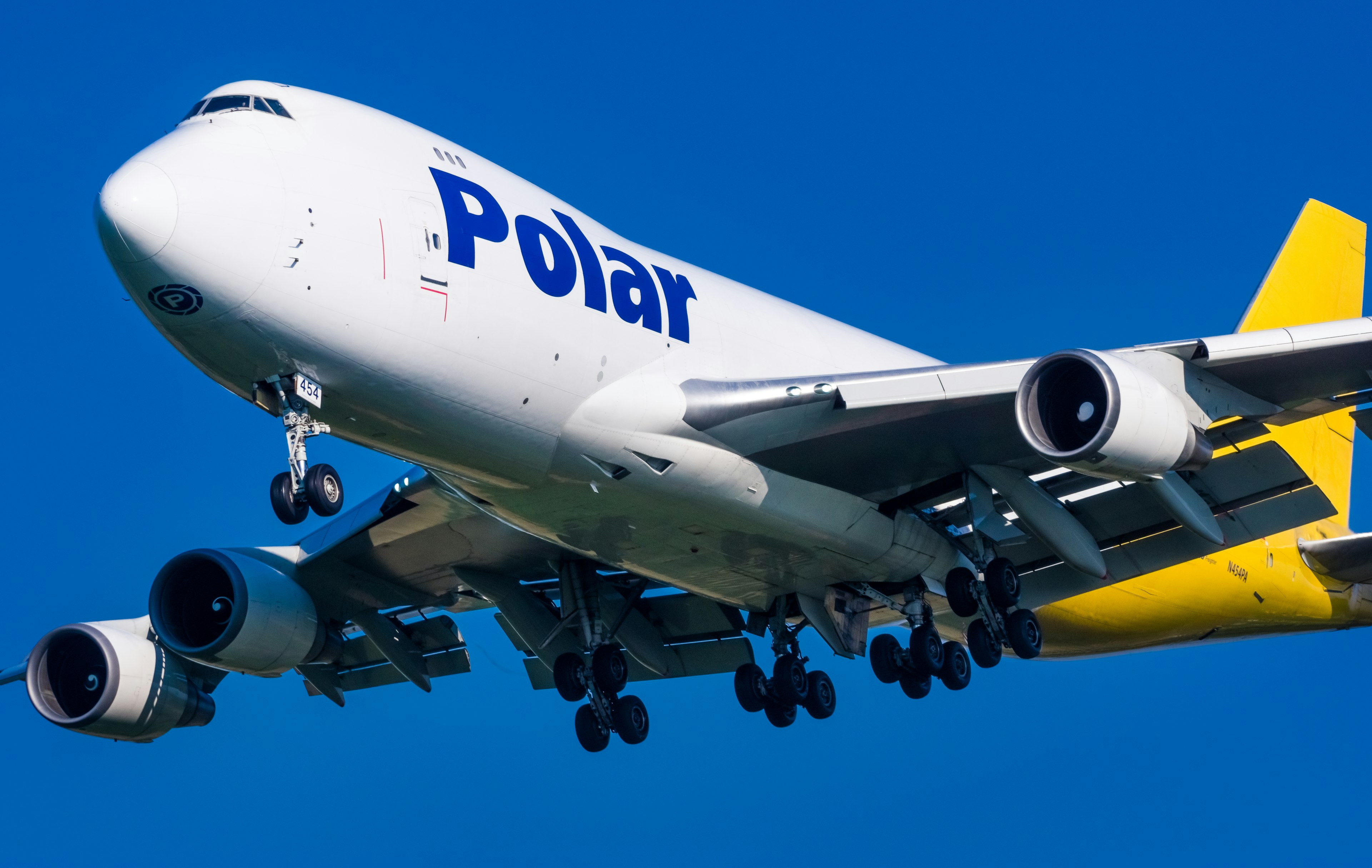 Polar Air Cargo plane approaching for landing against a blue sky