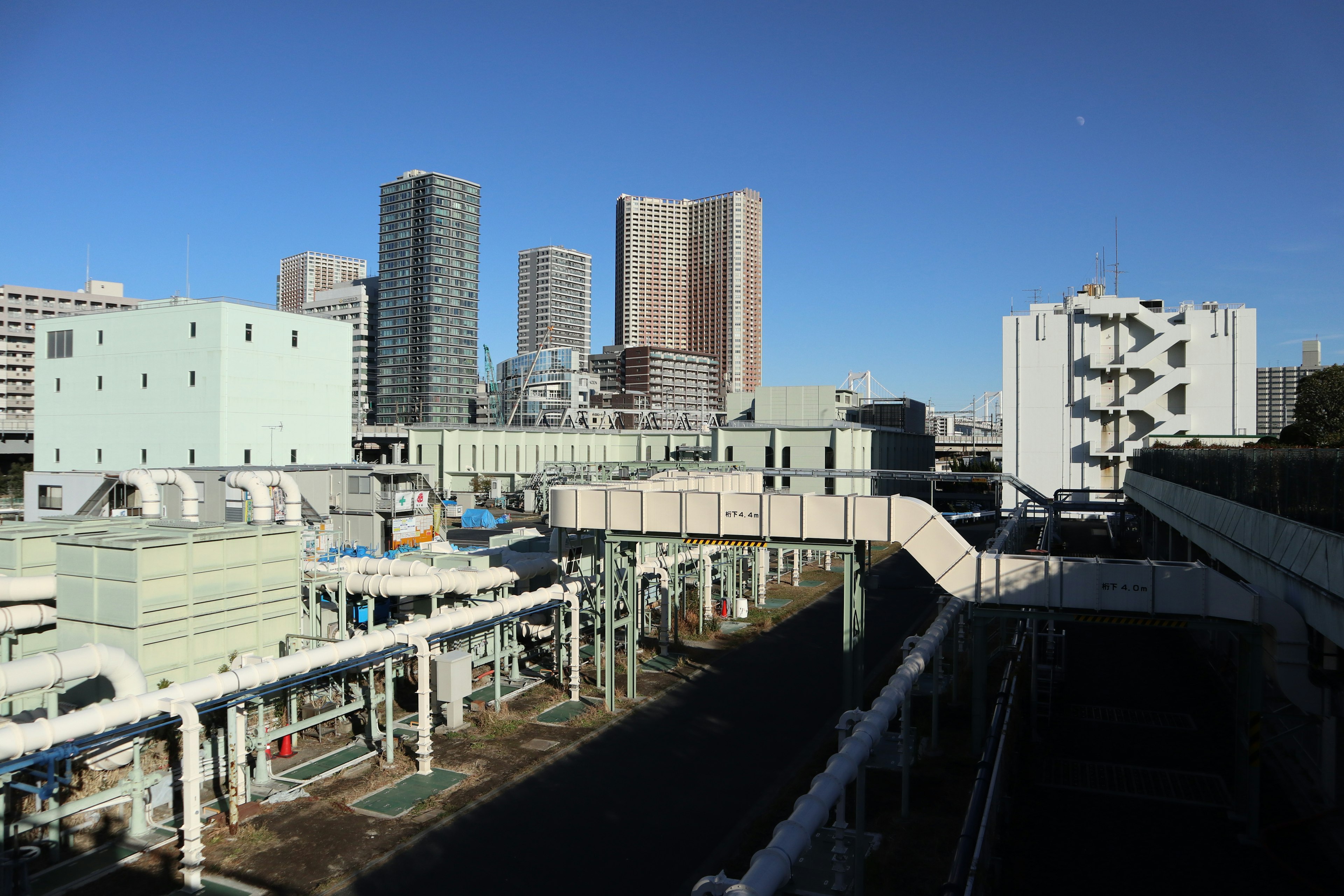 Industrial urban landscape featuring skyscrapers and pipelines