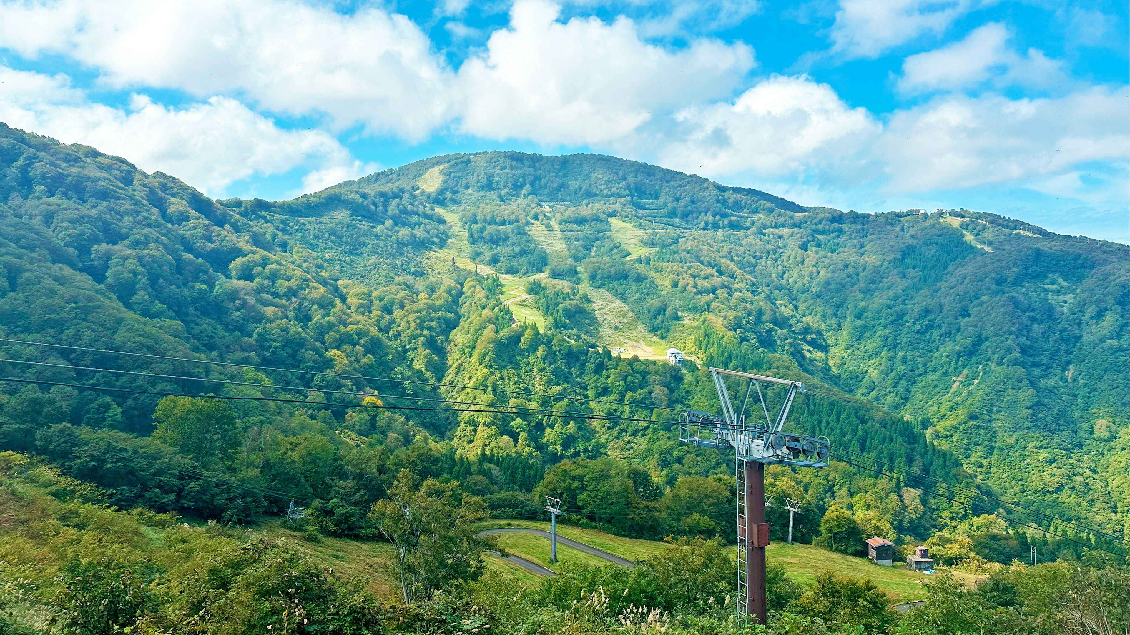 Scenic mountain landscape with ski lift under a blue sky