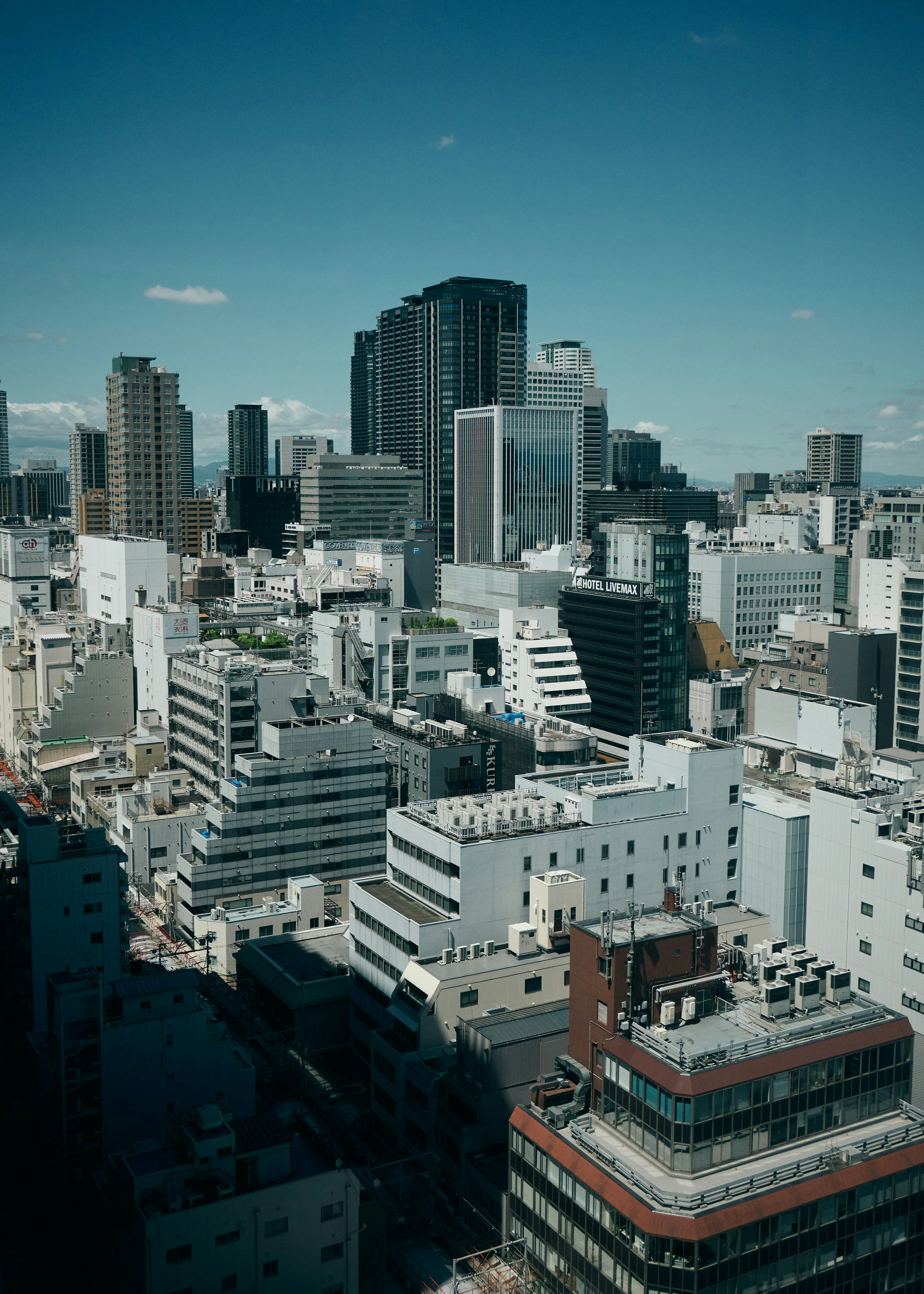 City skyline with high-rise buildings and blue sky