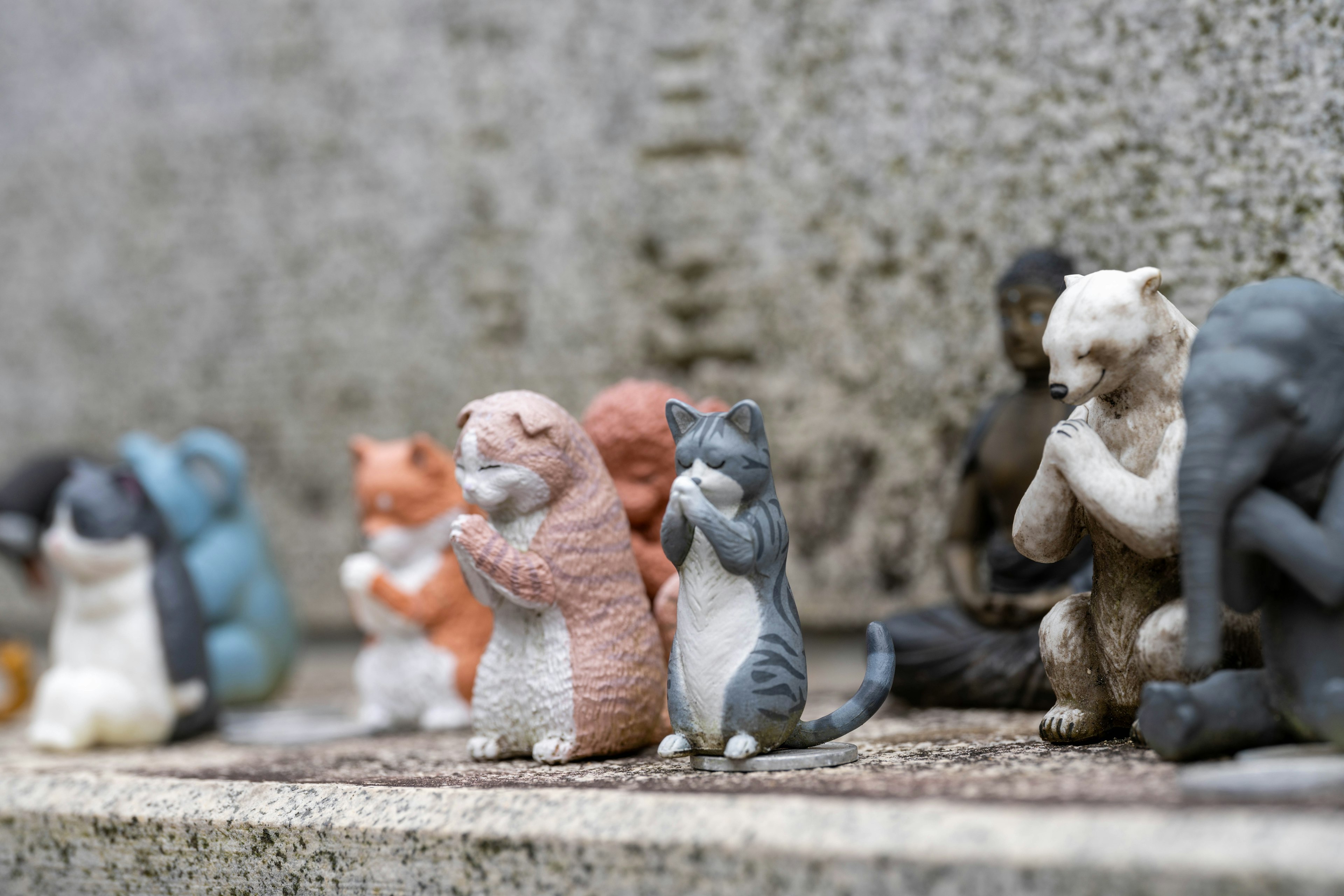 A collection of small ceramic animal figurines arranged in a row