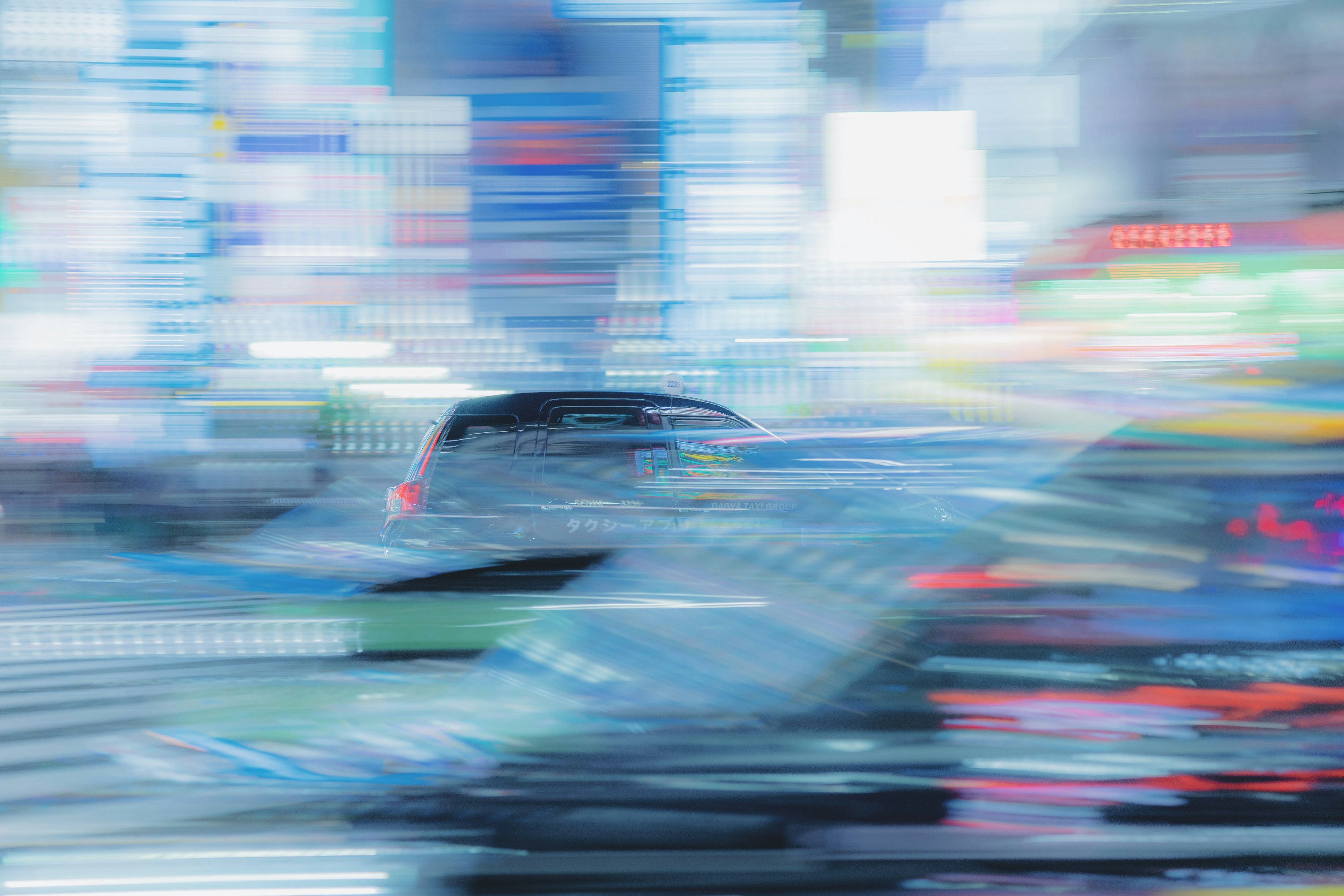 Blurry cityscape with moving cars and neon lights