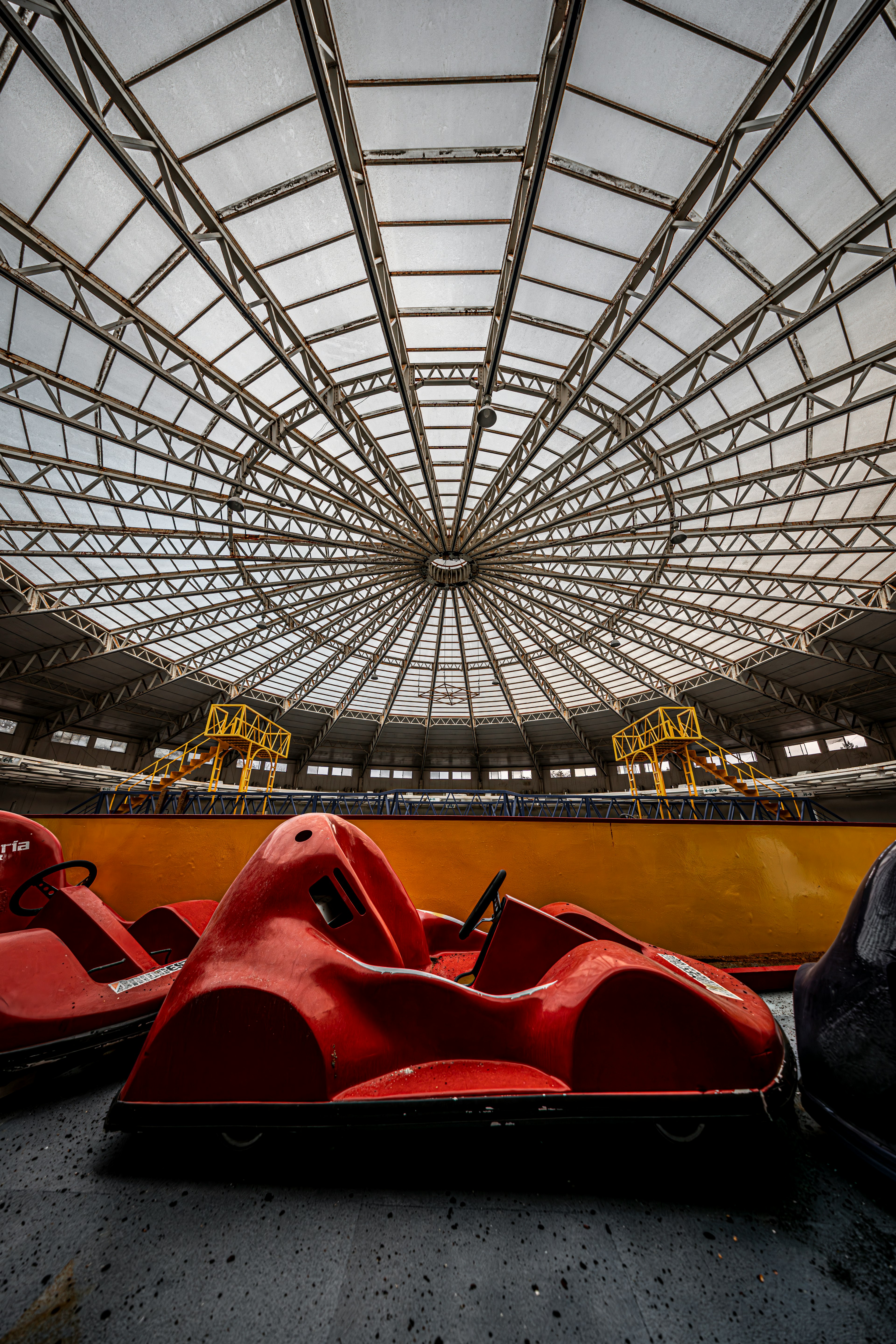 Red go-karts positioned in an indoor amusement park