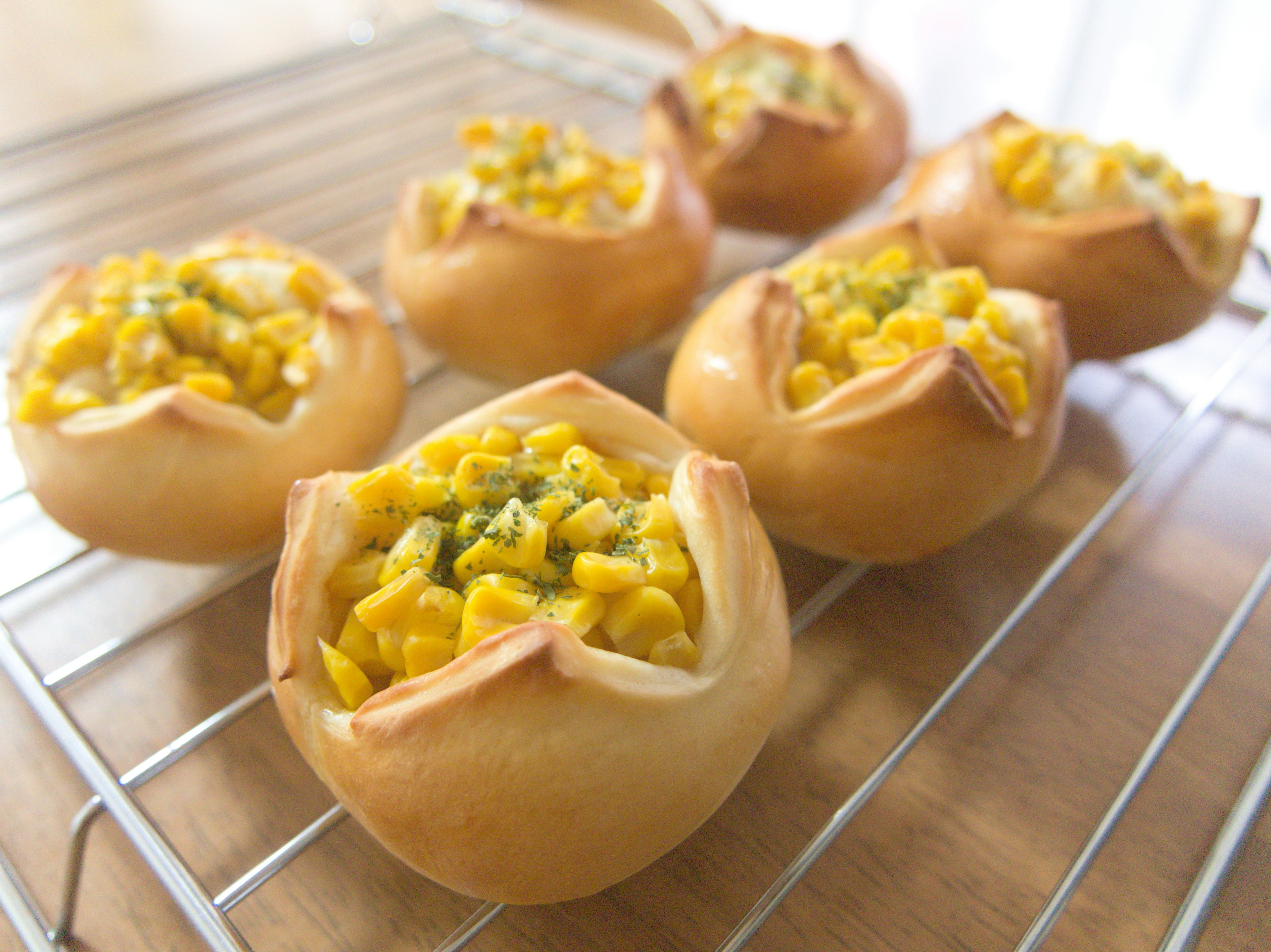 Freshly baked corn pies arranged on a wire rack