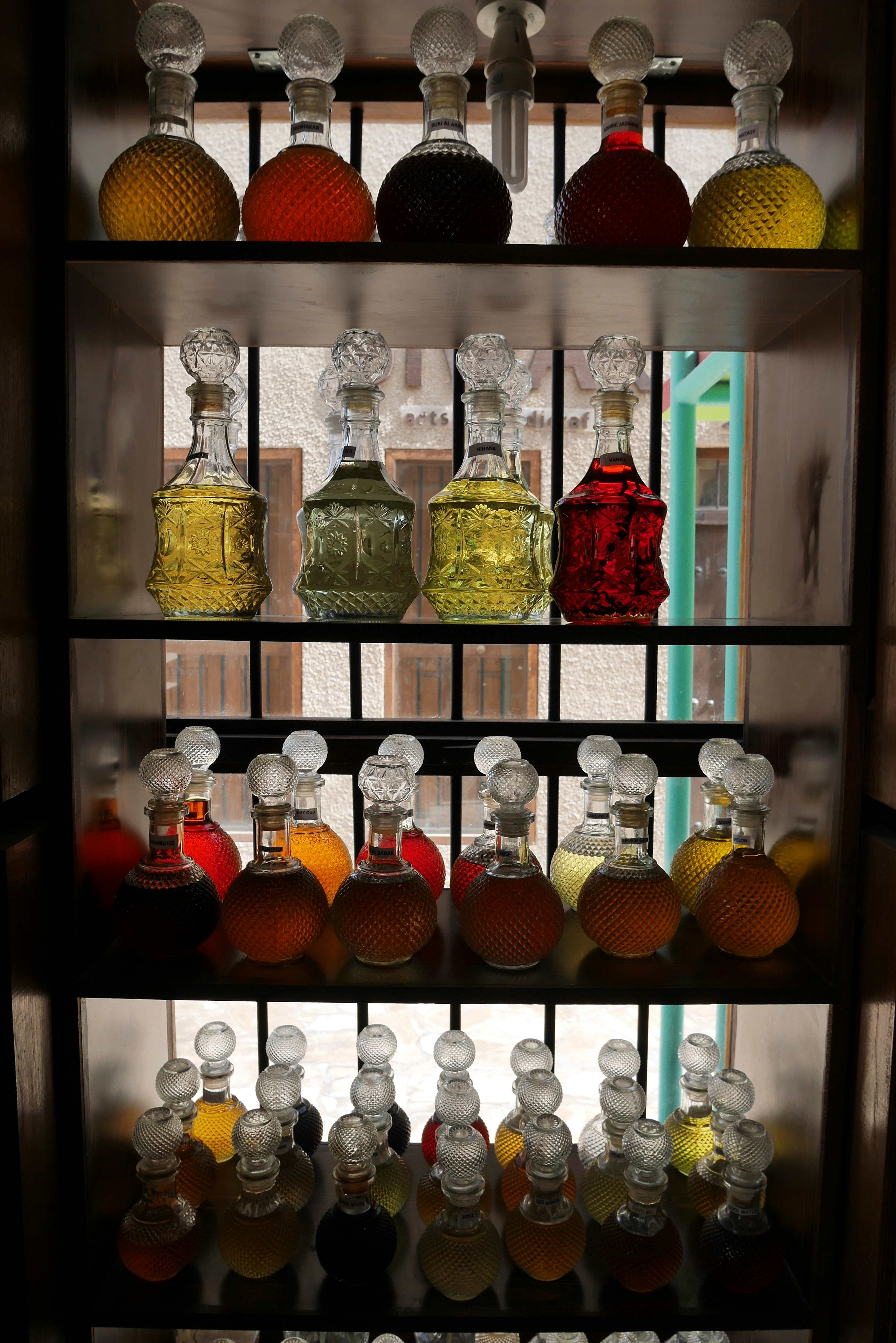 Image of a shelf displaying colorful glass bottles