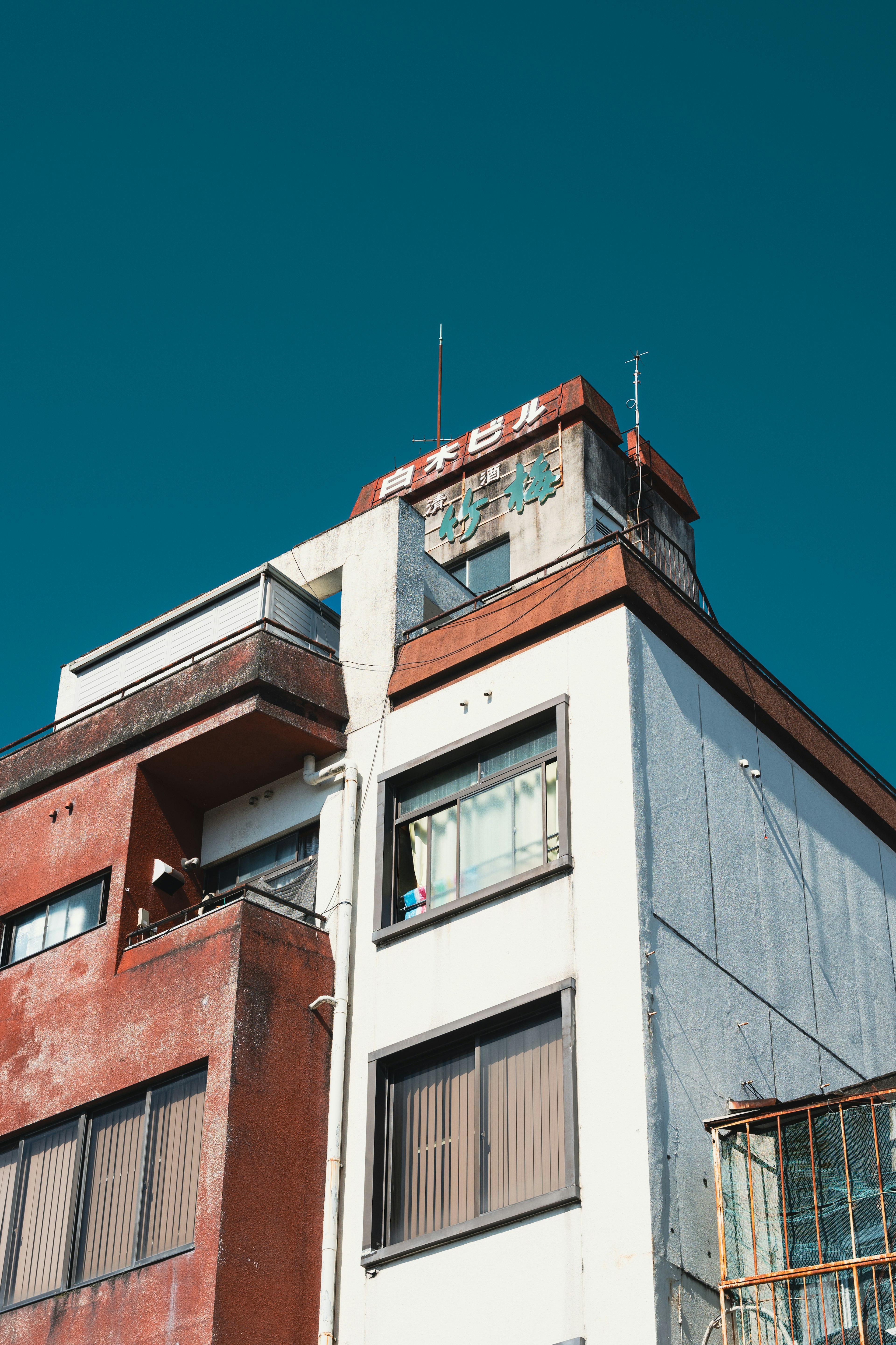 Unique architectural features of a weathered building against a clear blue sky