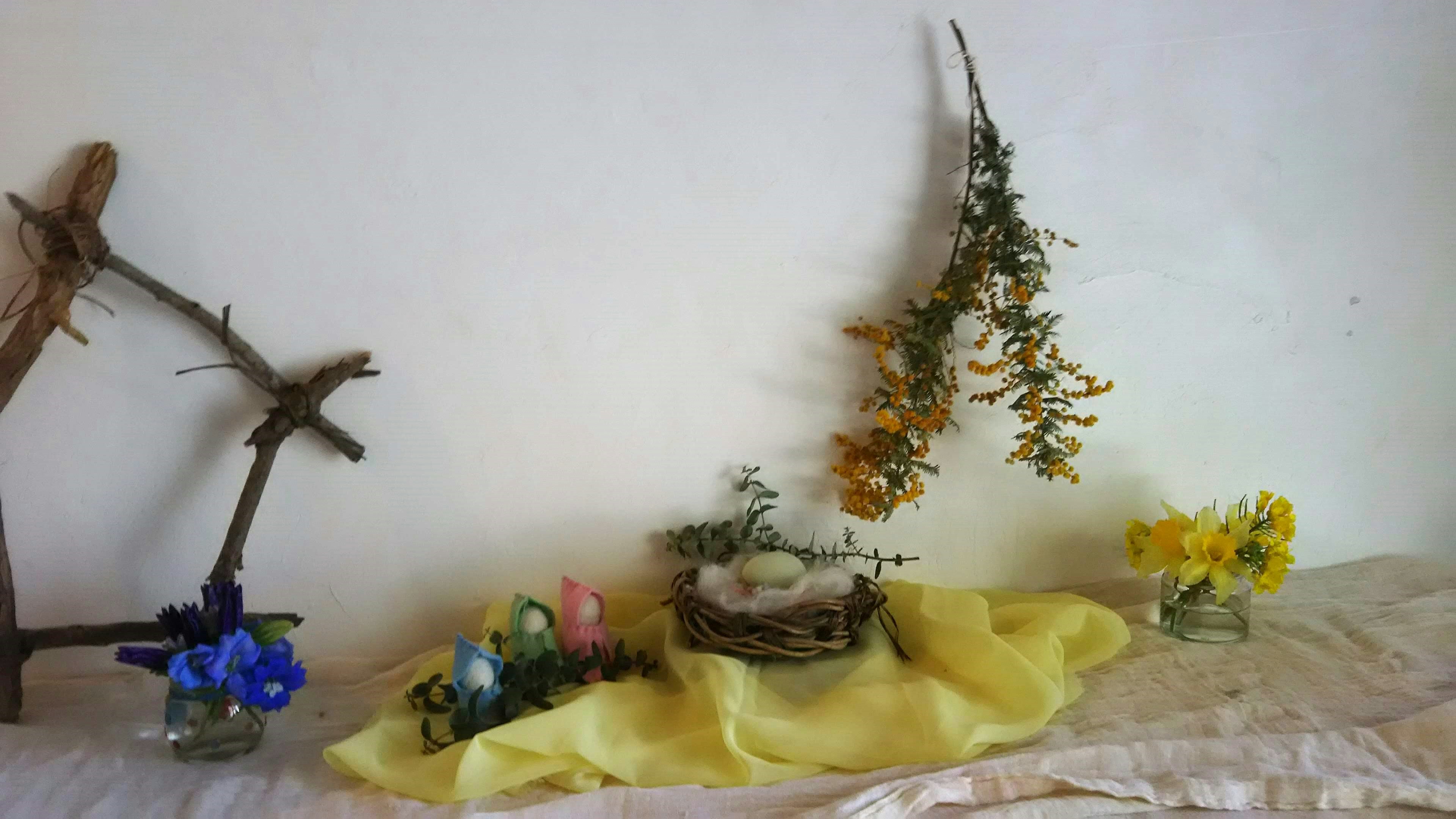 Spring decoration table with colorful eggs and flowers