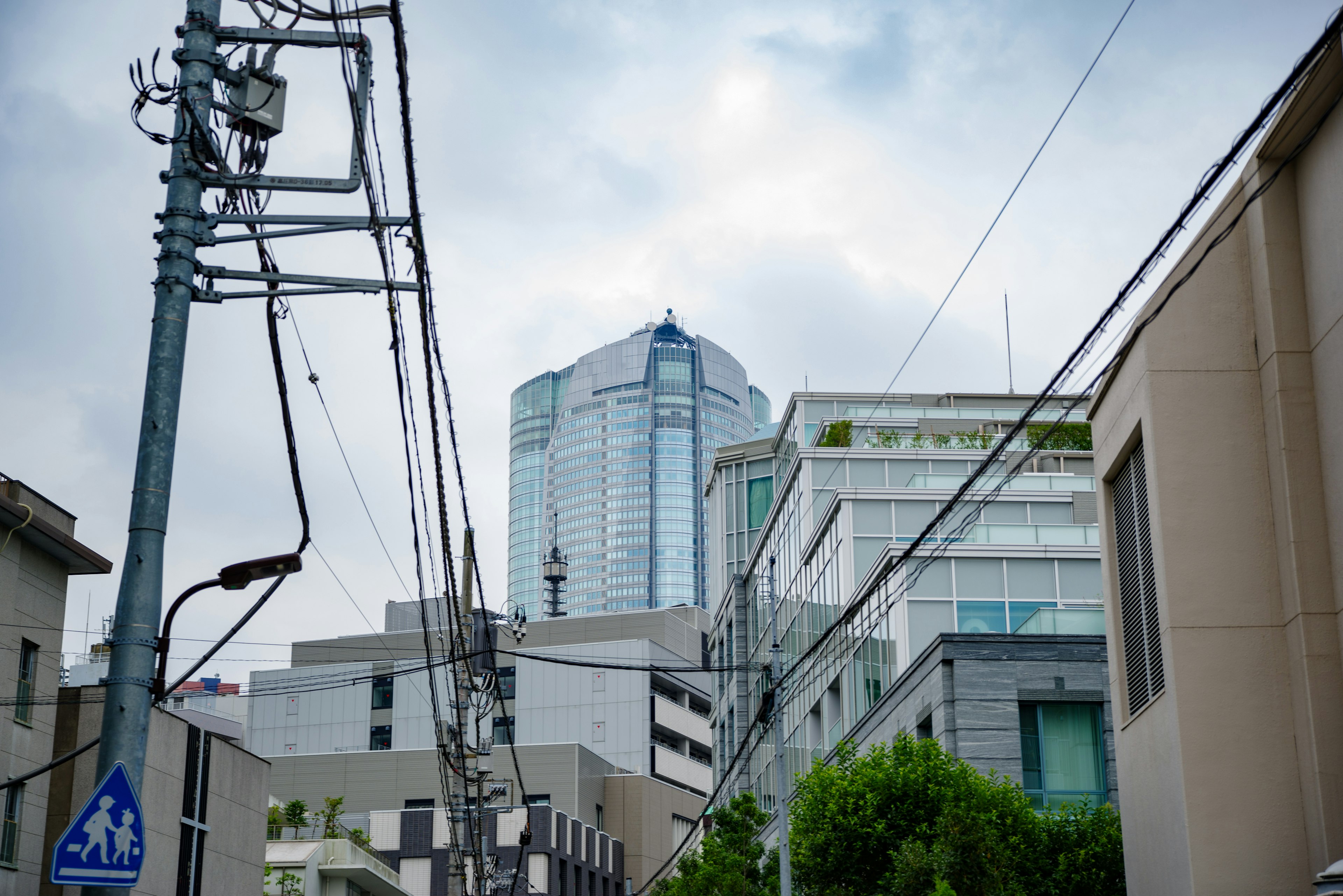 Urban scene featuring a tall building and power lines