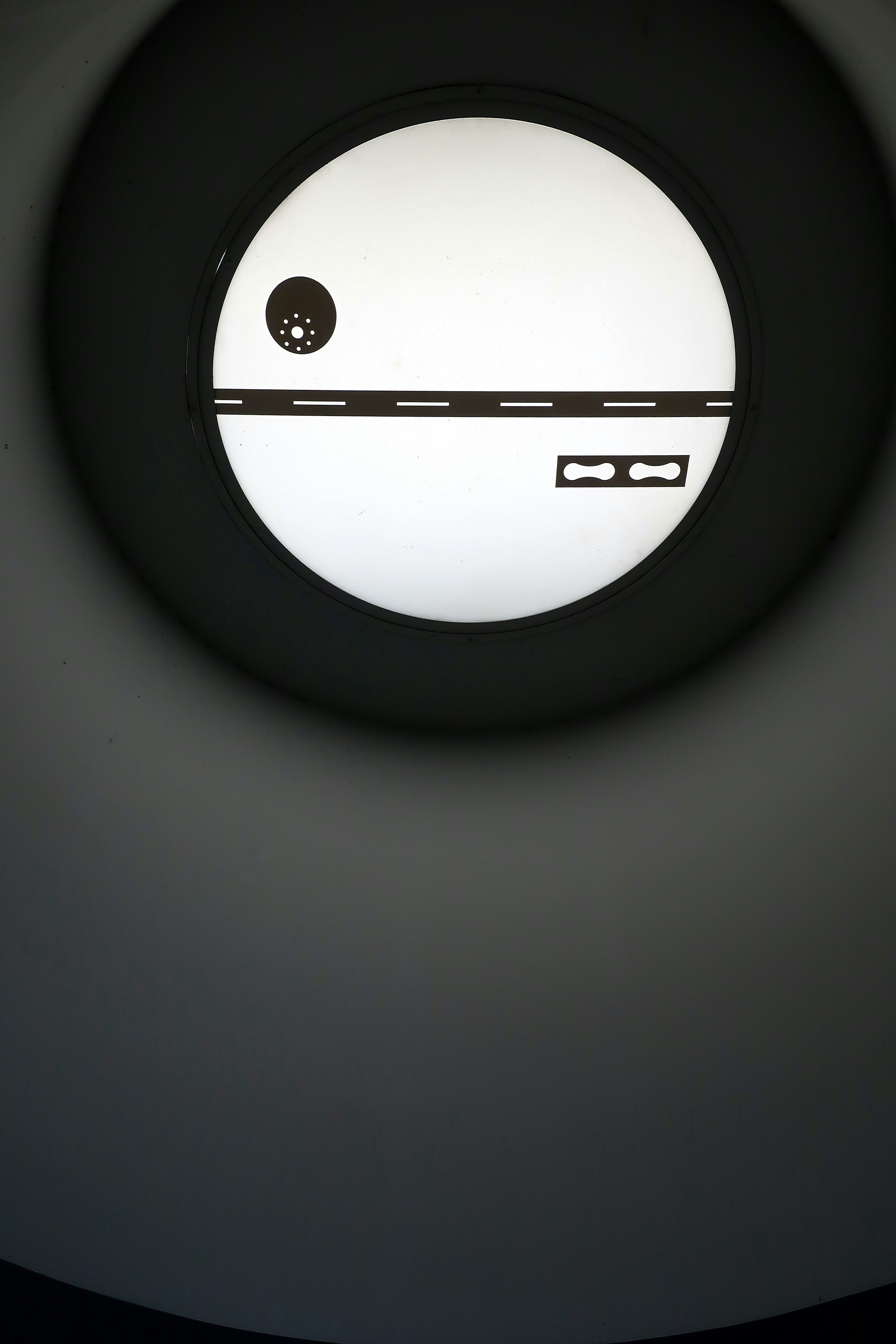 A round window featuring a simple design with a white background and black lines