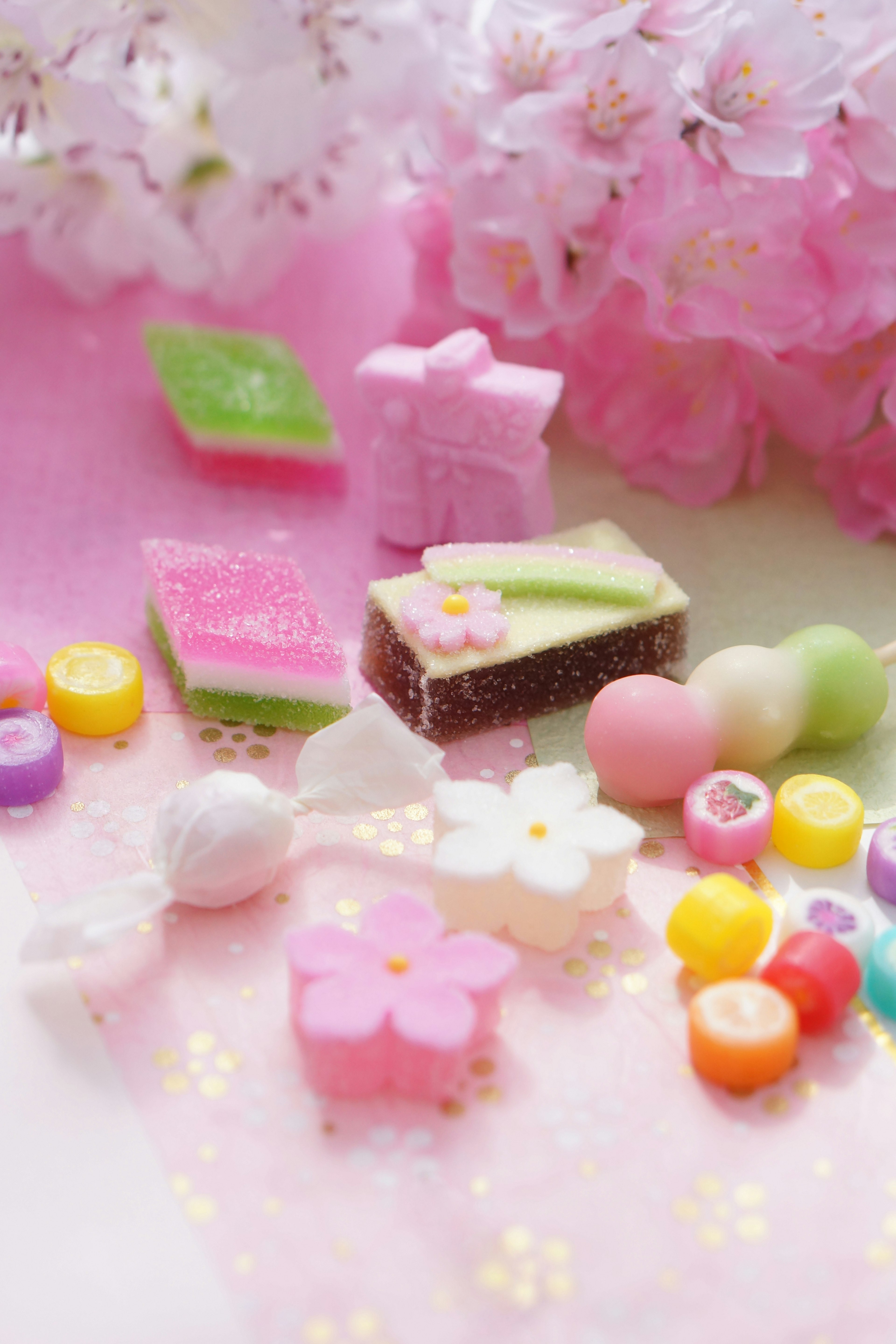 Colorful sweets arrangement with cherry blossoms and various candies