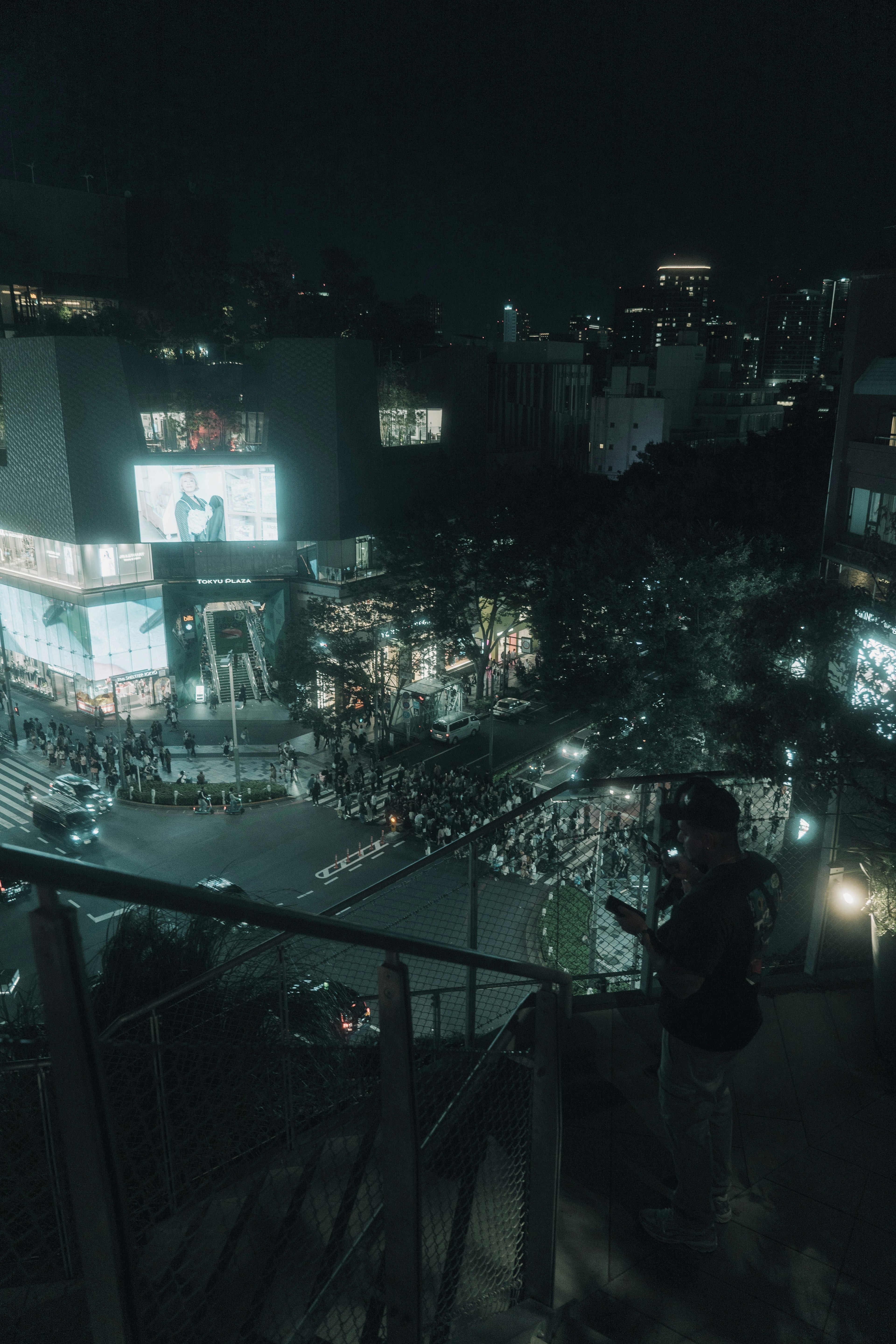 View of Shibuya Crossing at night with crowds of people