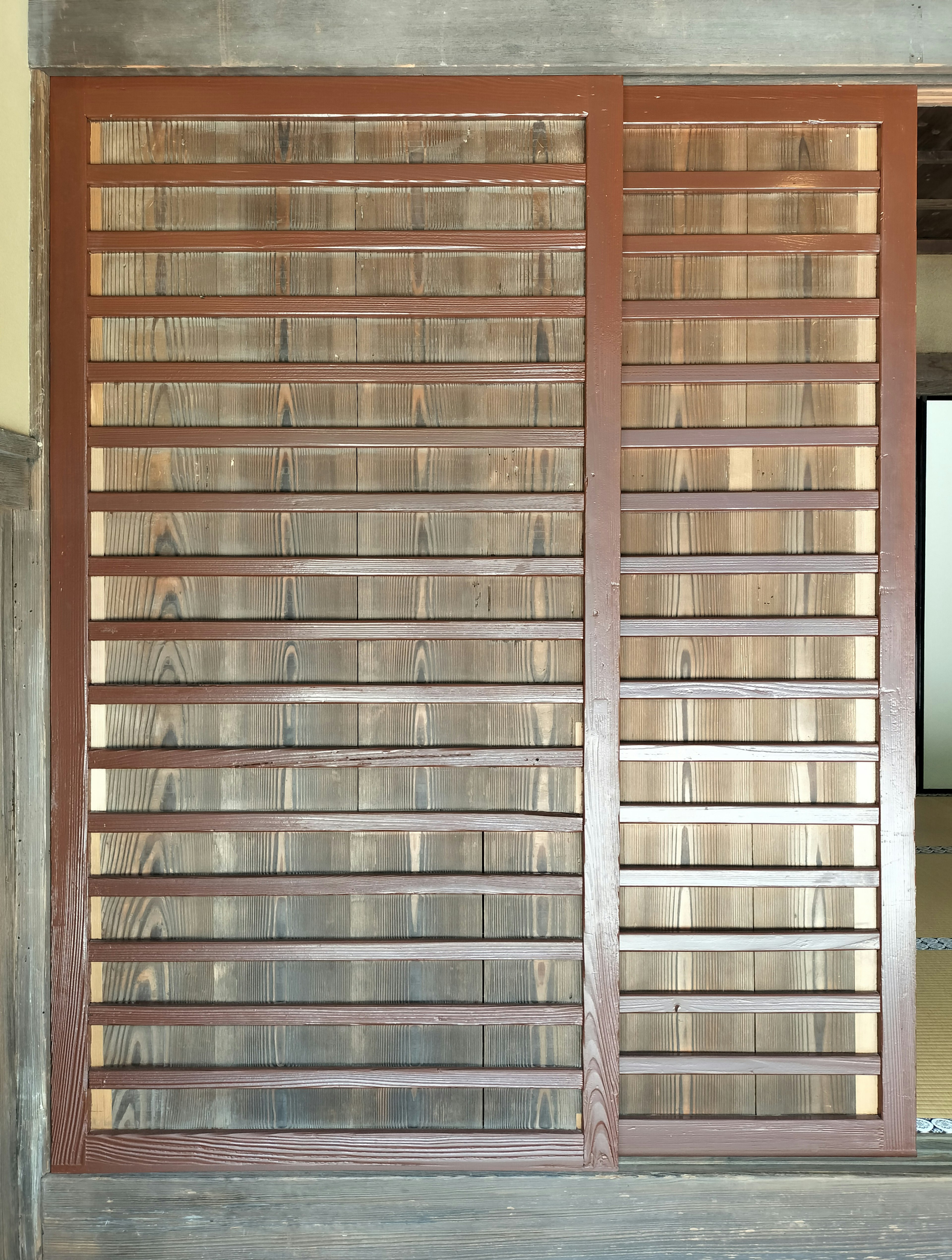 Wooden slatted design of a sliding door panel