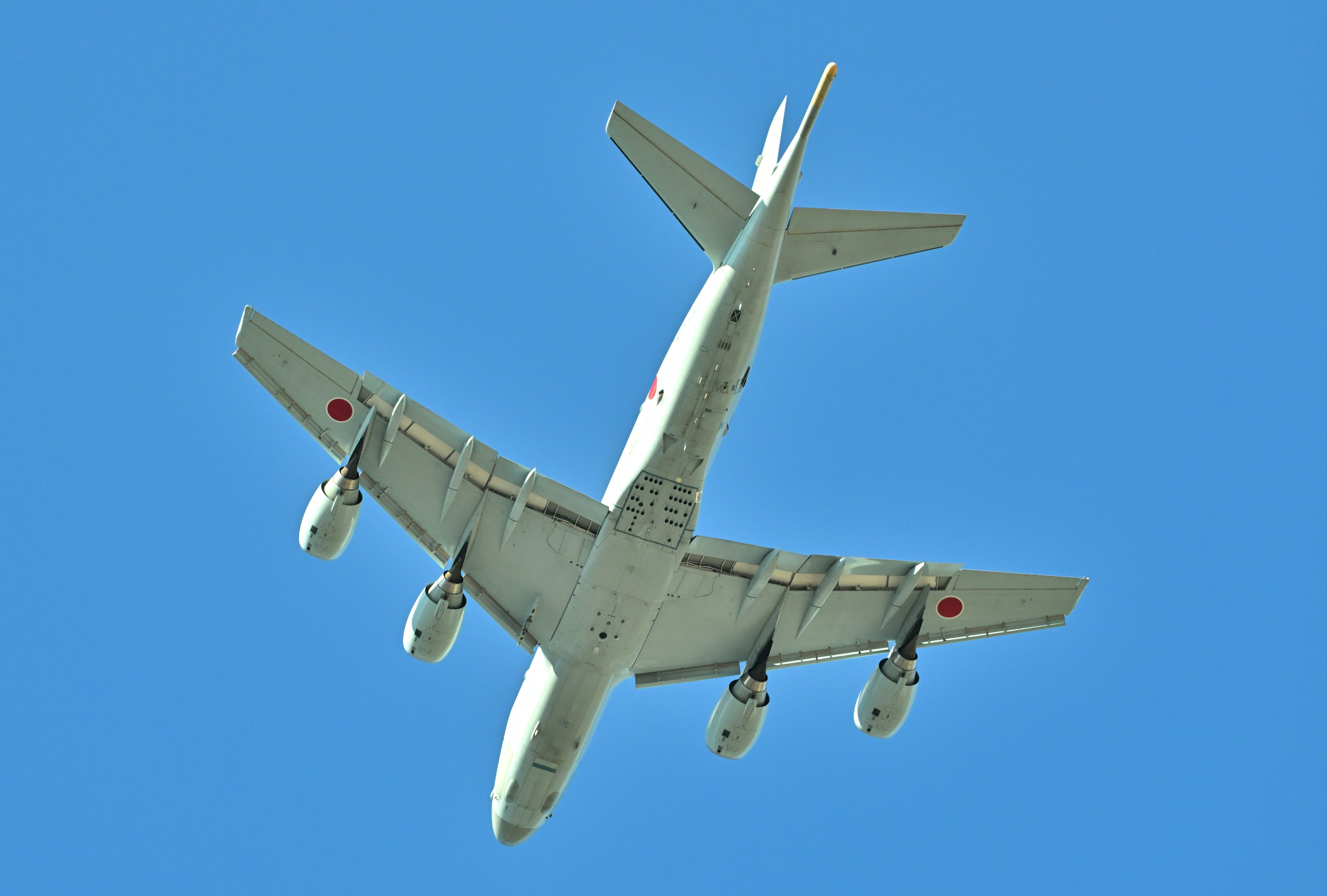 Aircraft viewed from below against a blue sky