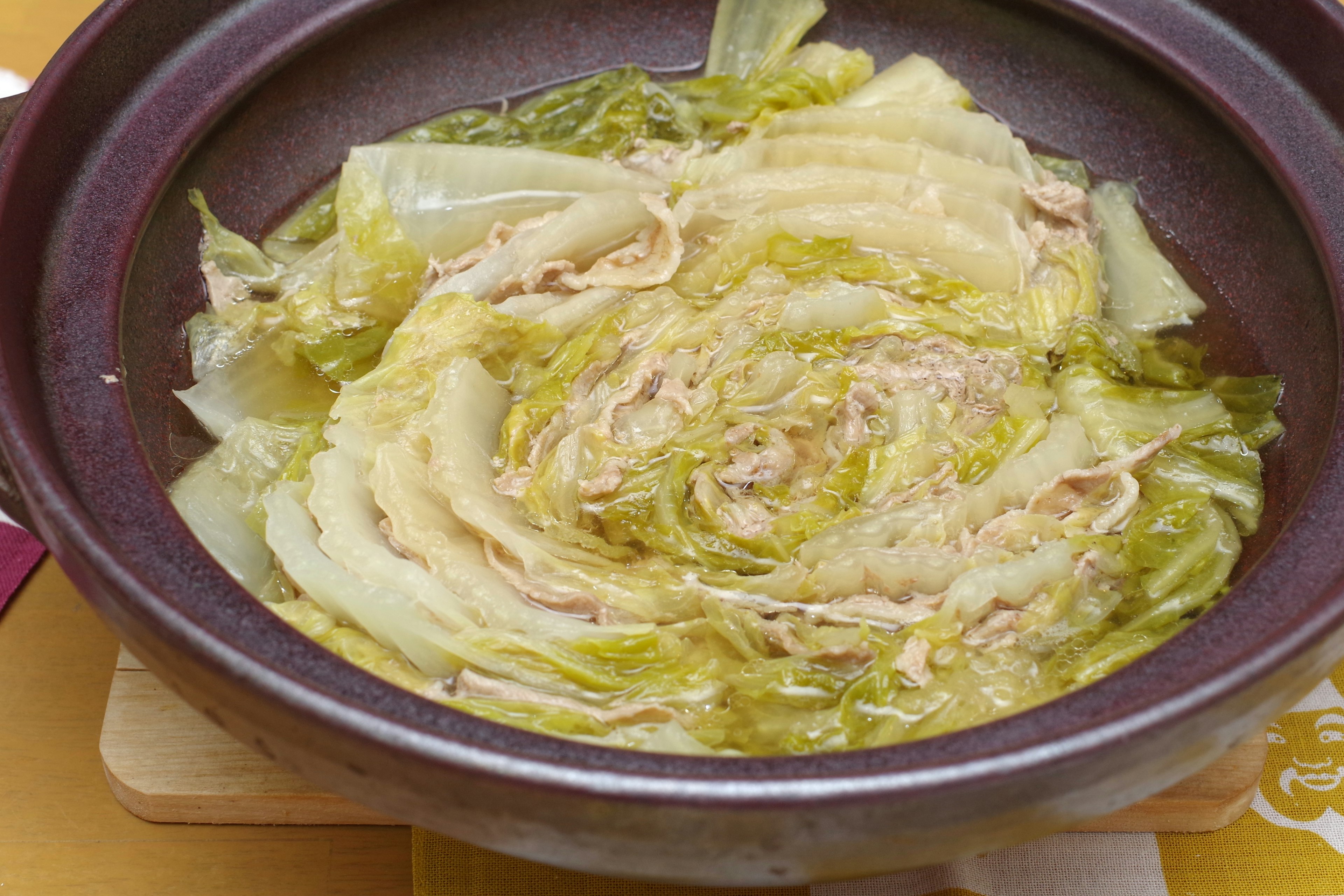 A dish of cabbage and chicken served in a pot