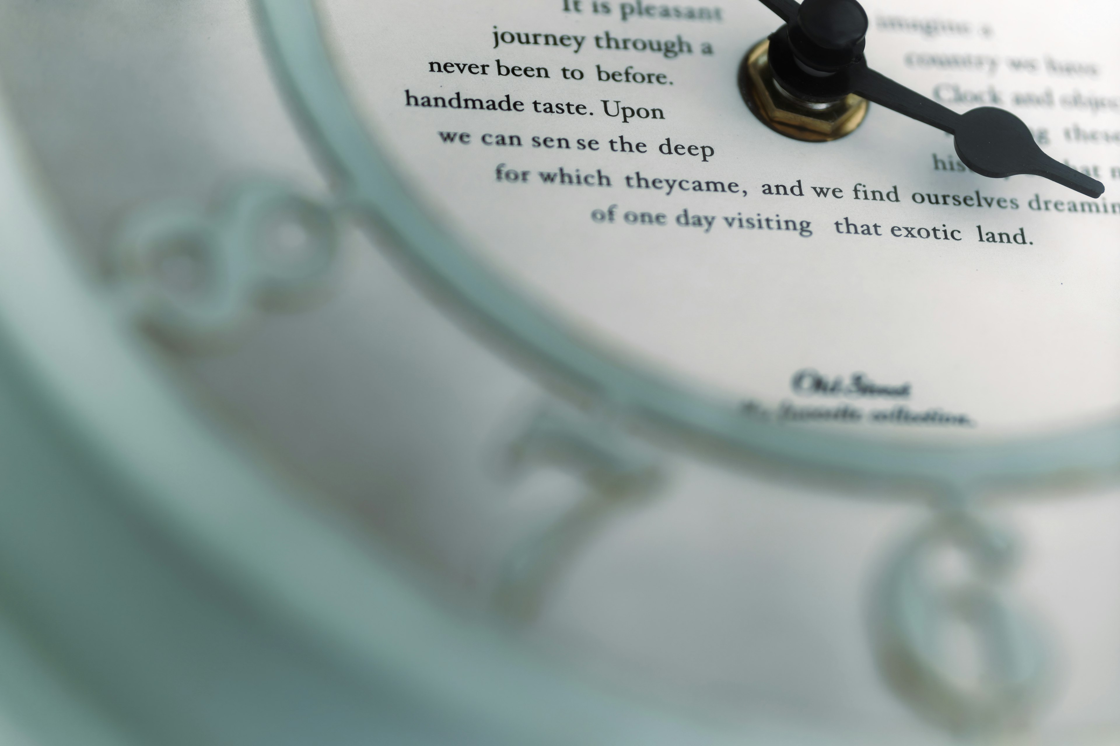 Close-up of a blue clock with printed text on the face