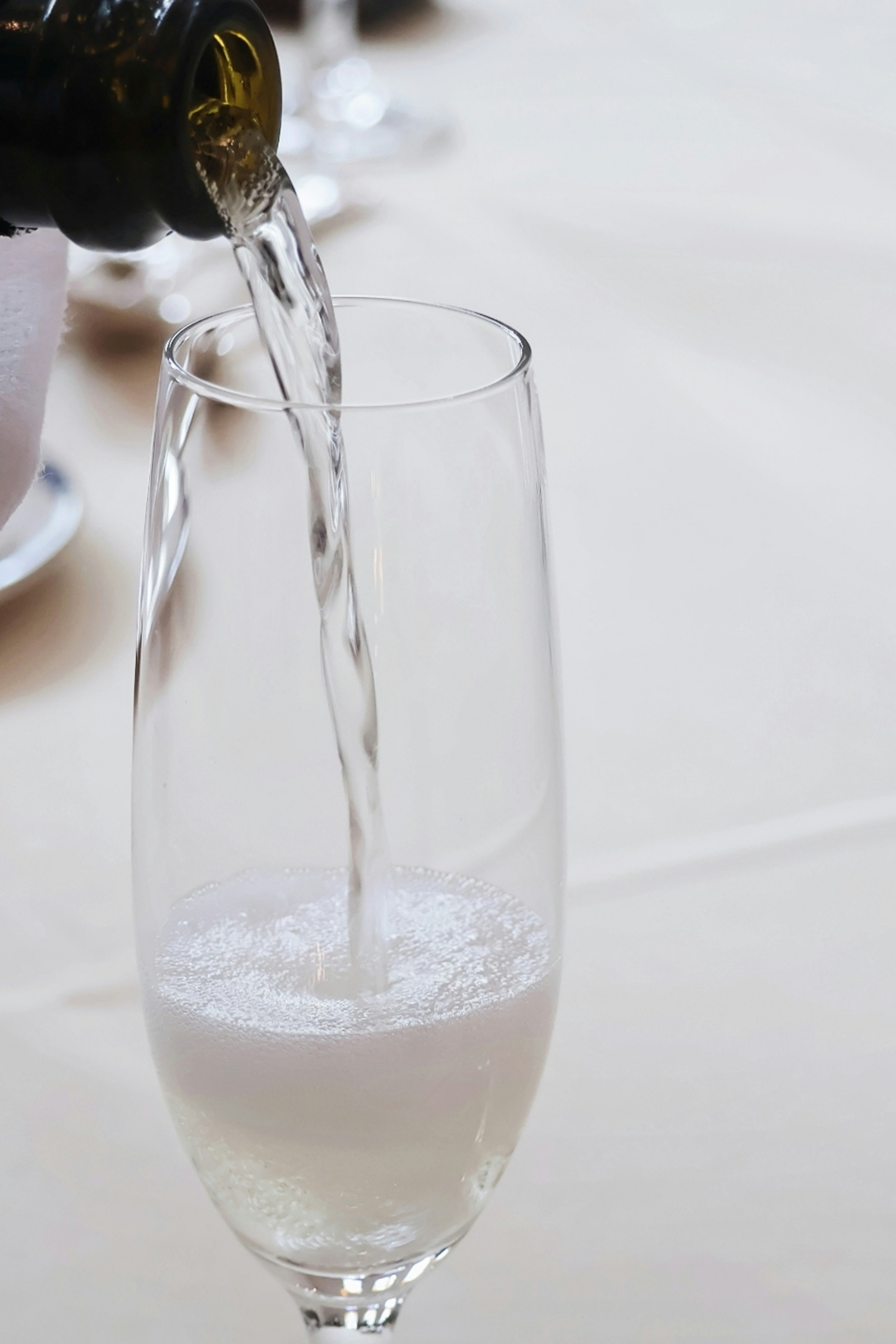 Champagne being poured into a flute glass