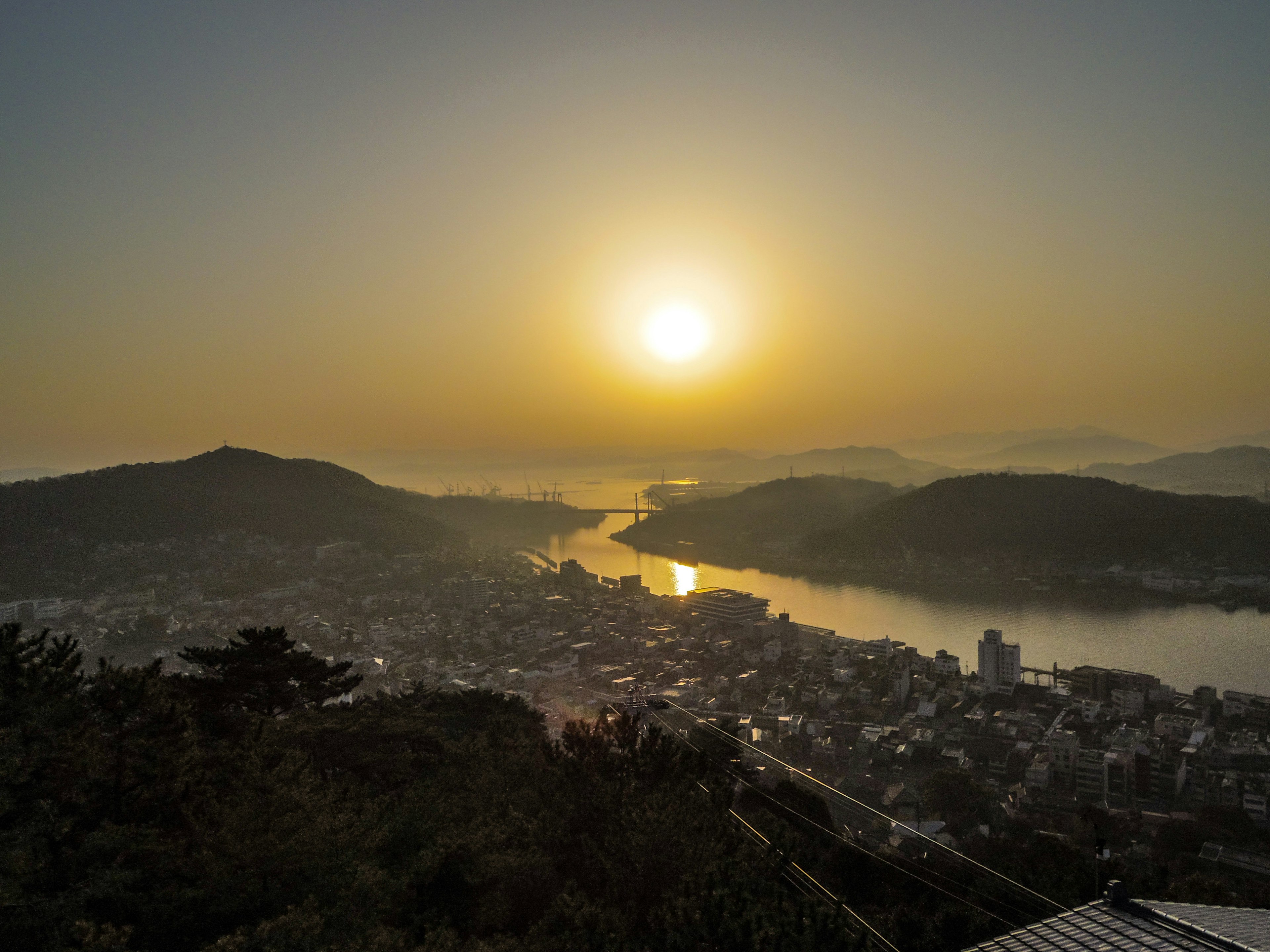 美しい夕日が河川と町を照らす風景