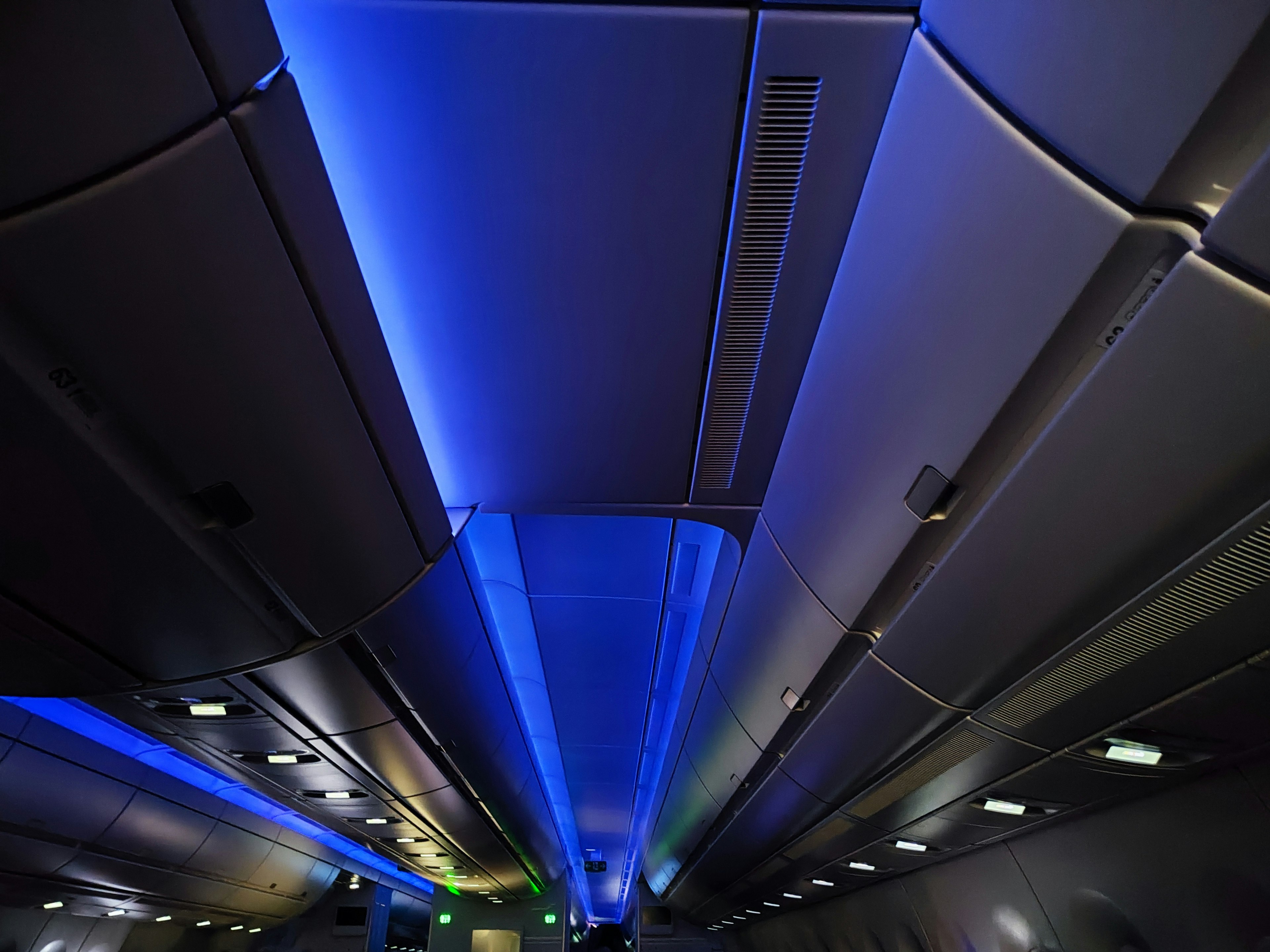 Immagine del soffitto della cabina di un aereo illuminato con luci blu