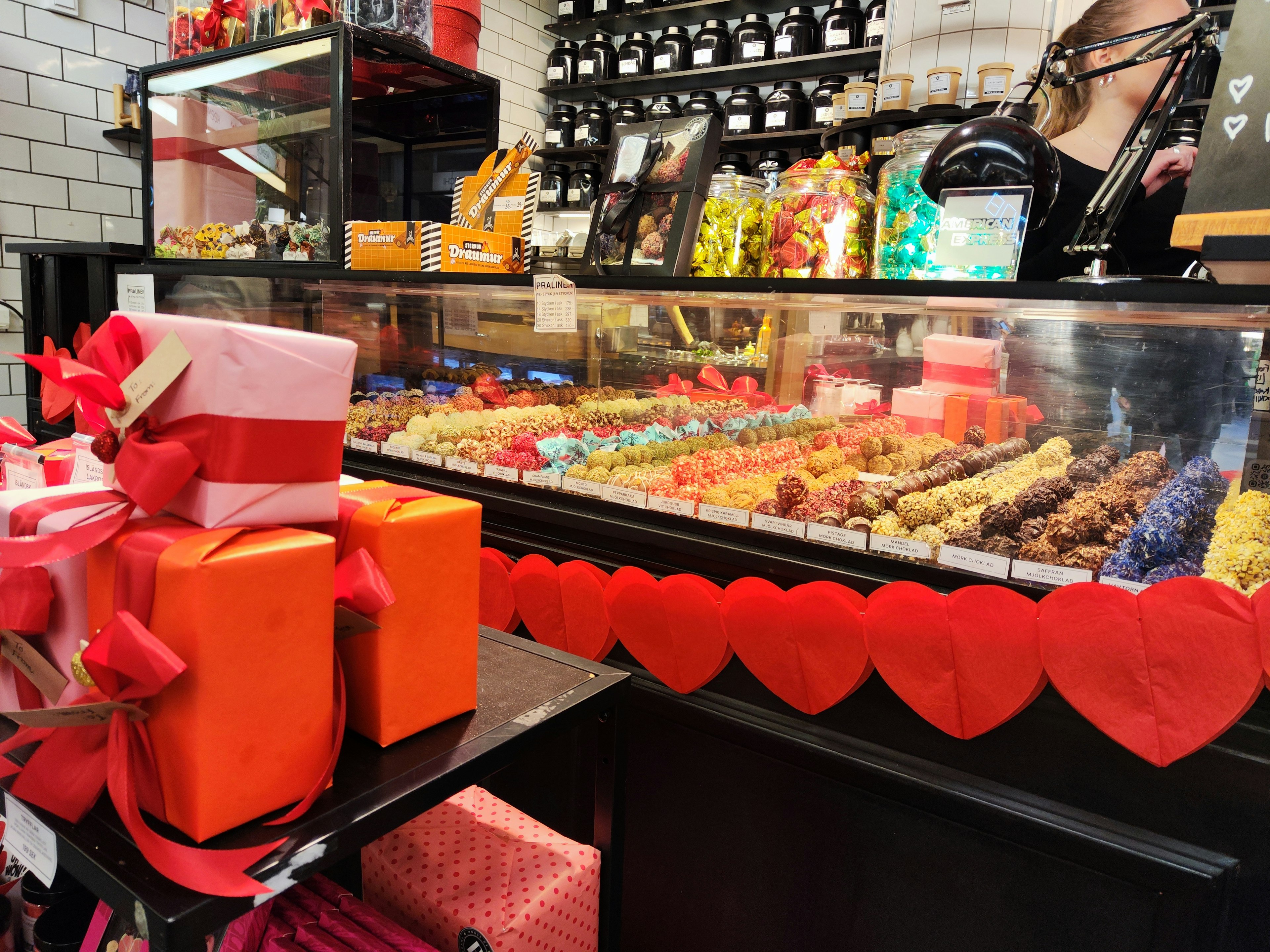 Interior of a sweets shop featuring colorful chocolates and gift boxes