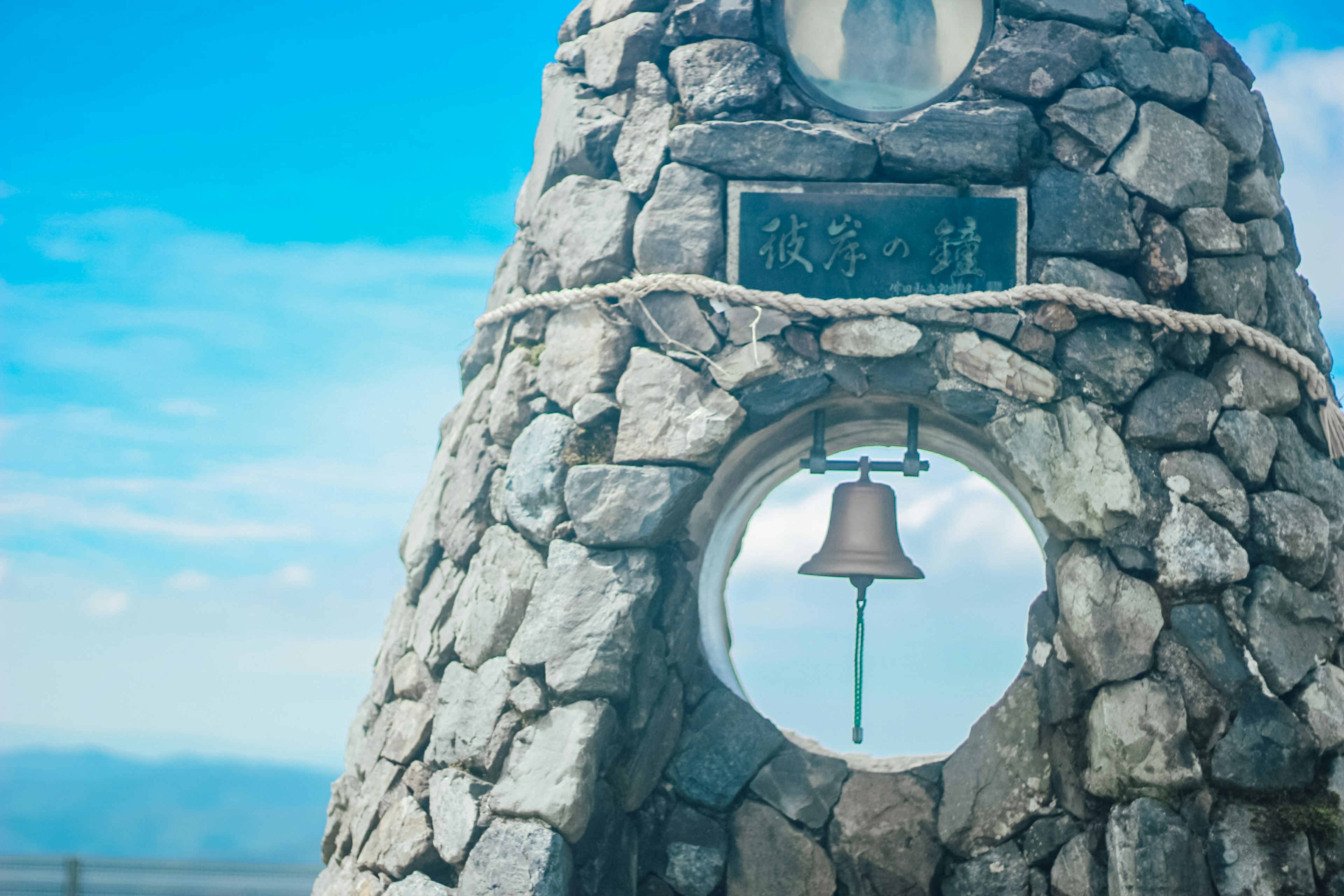 Stone bell tower with a blue sky background