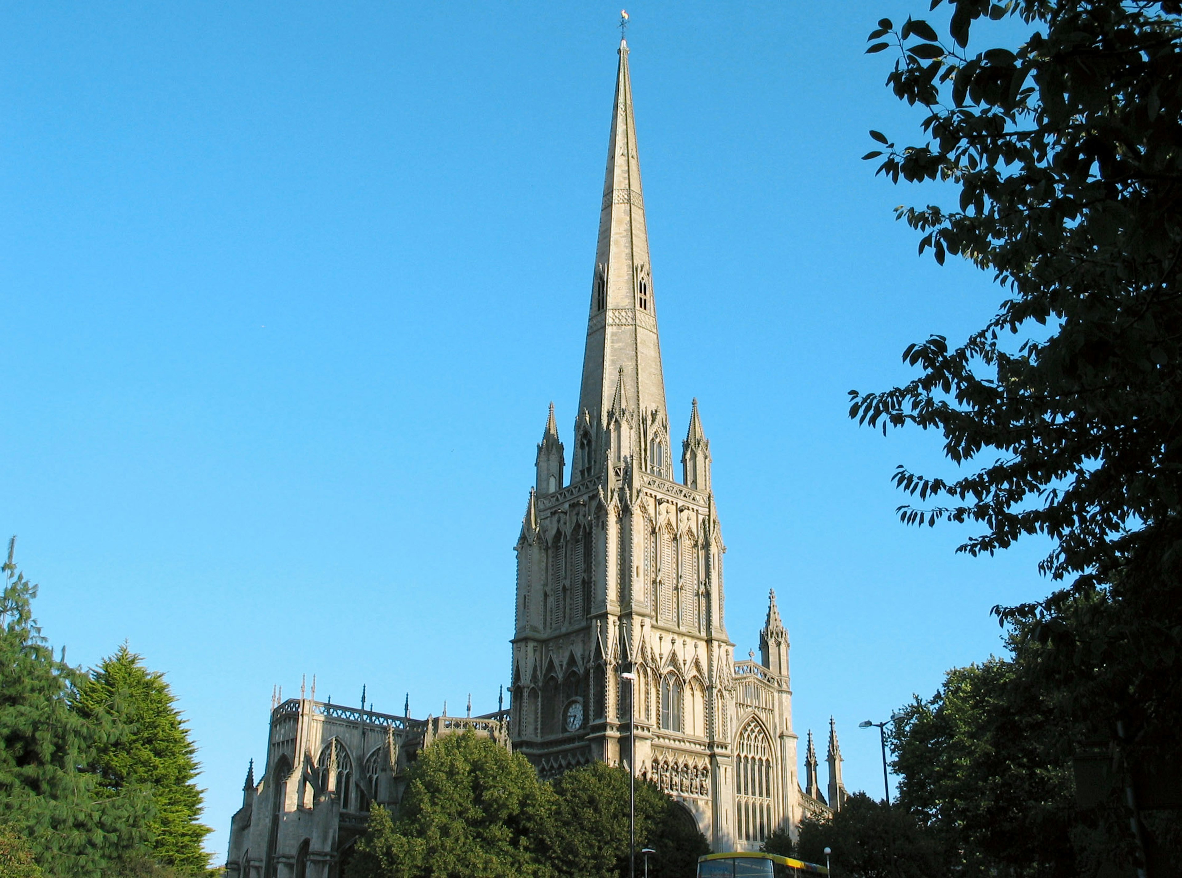 A beautiful church spire towering under a clear blue sky