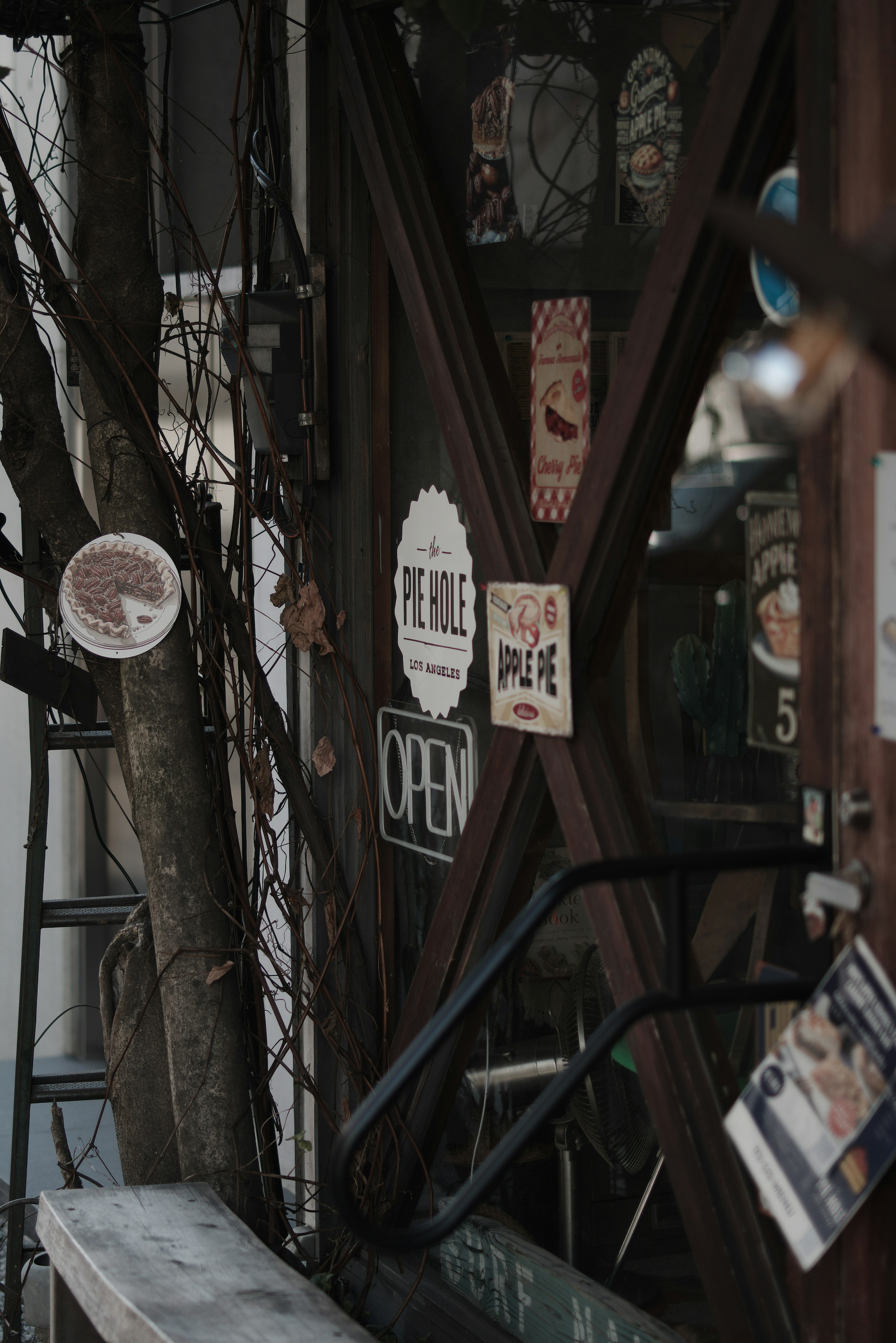 Exterior of a shop featuring various stickers and signs on a wooden door