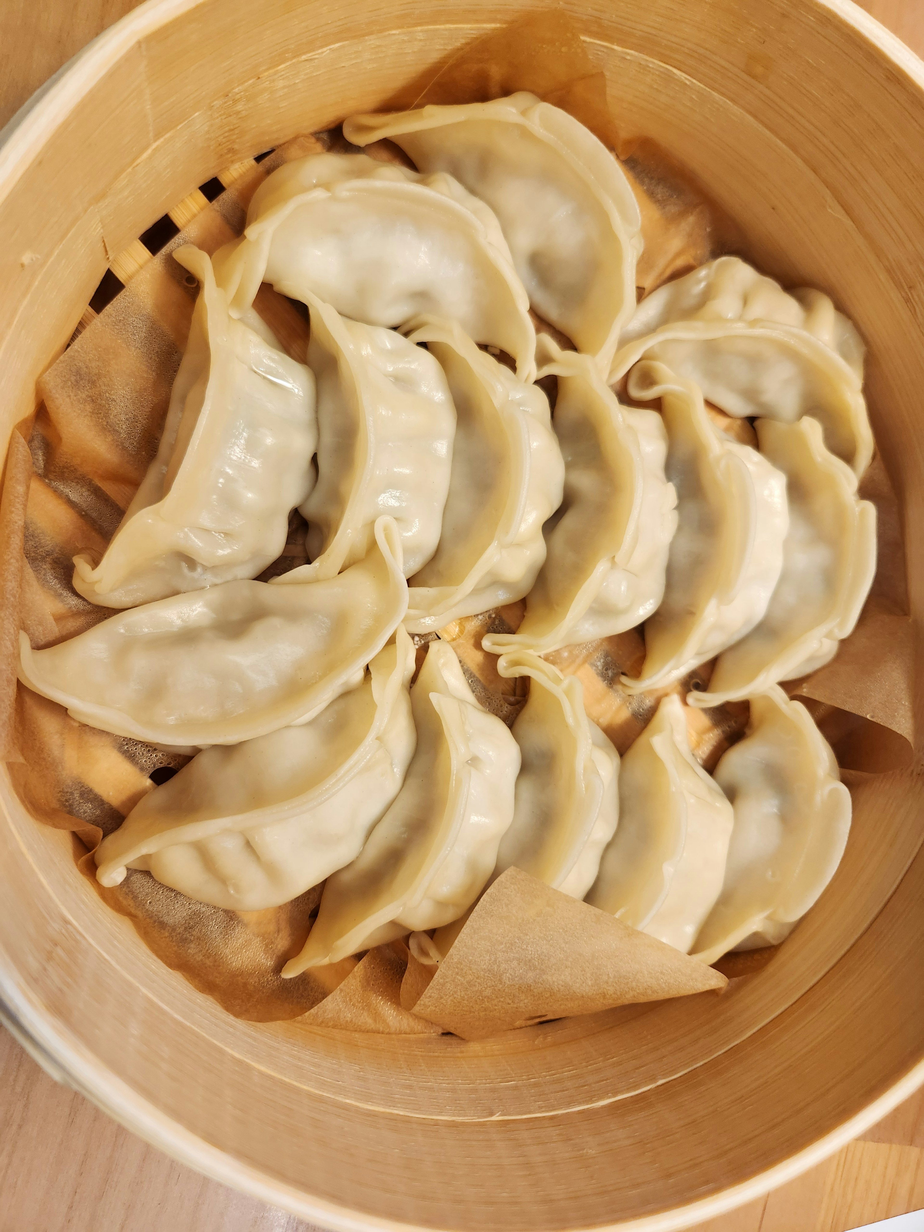 Steamed dumplings arranged in a bamboo steamer