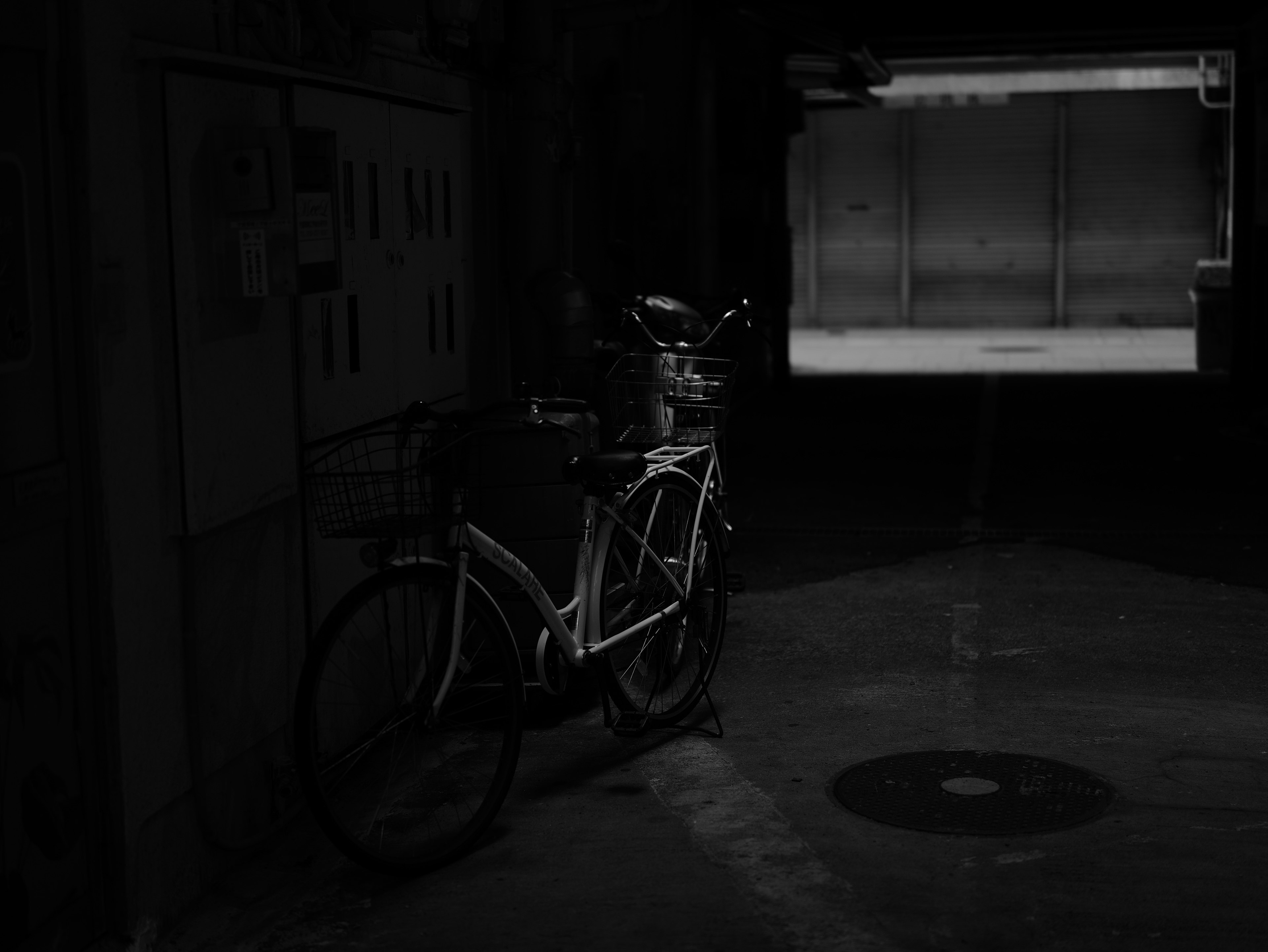 Bicycle in a dark space with light from an open door