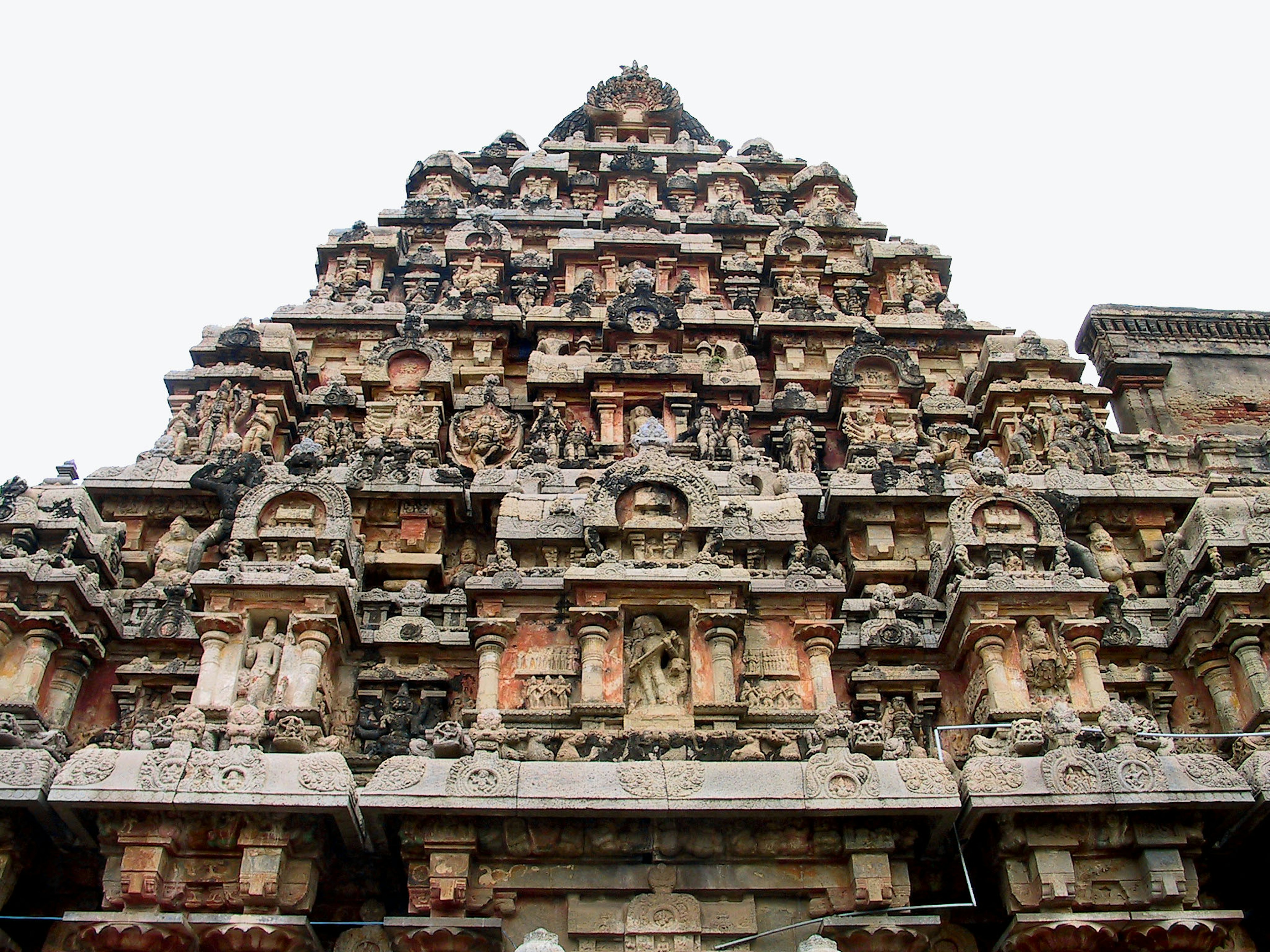 Grand stone tower of an ancient temple featuring intricate carvings and decorations