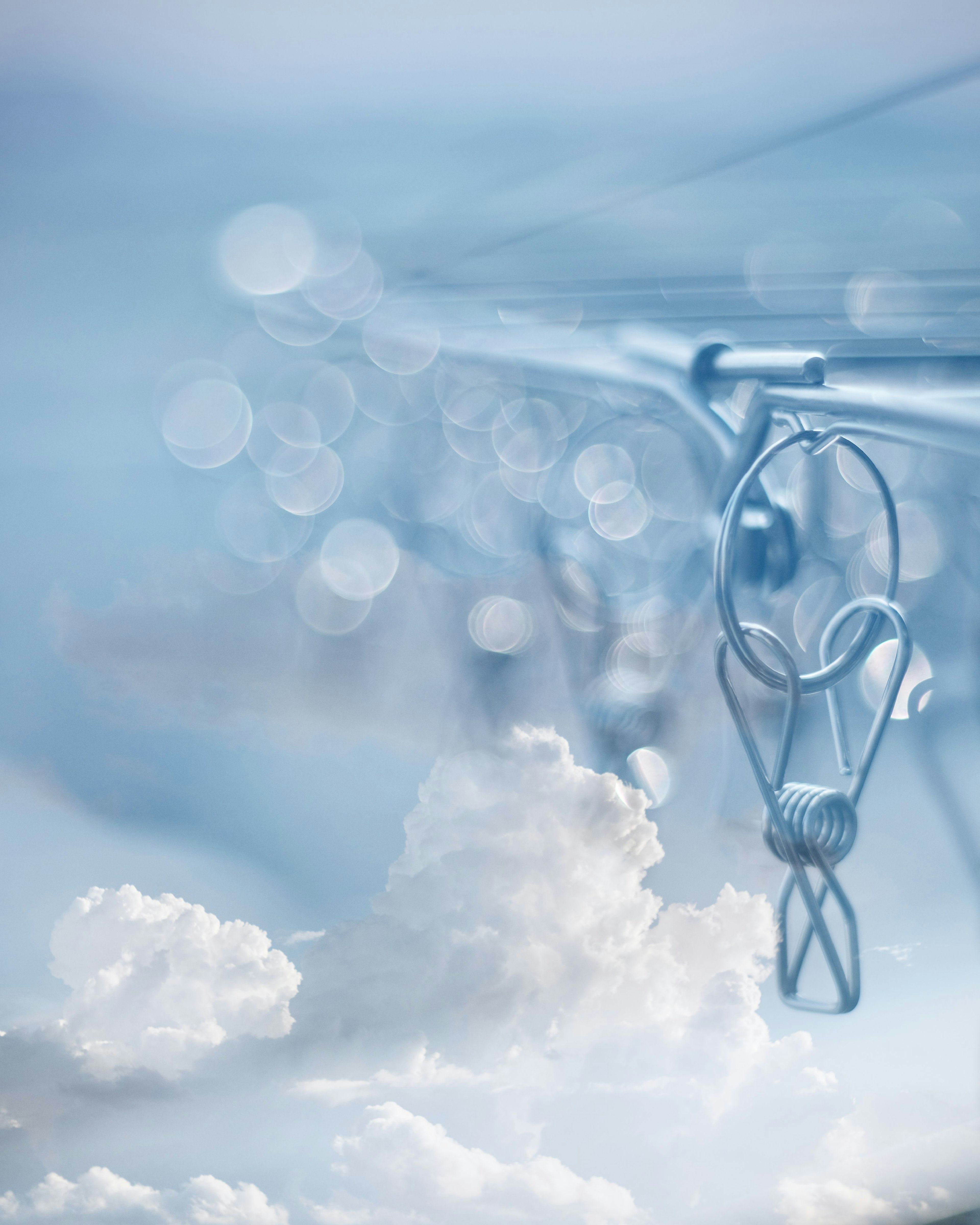 Close-up of a clip against a blue sky background with blurred clouds