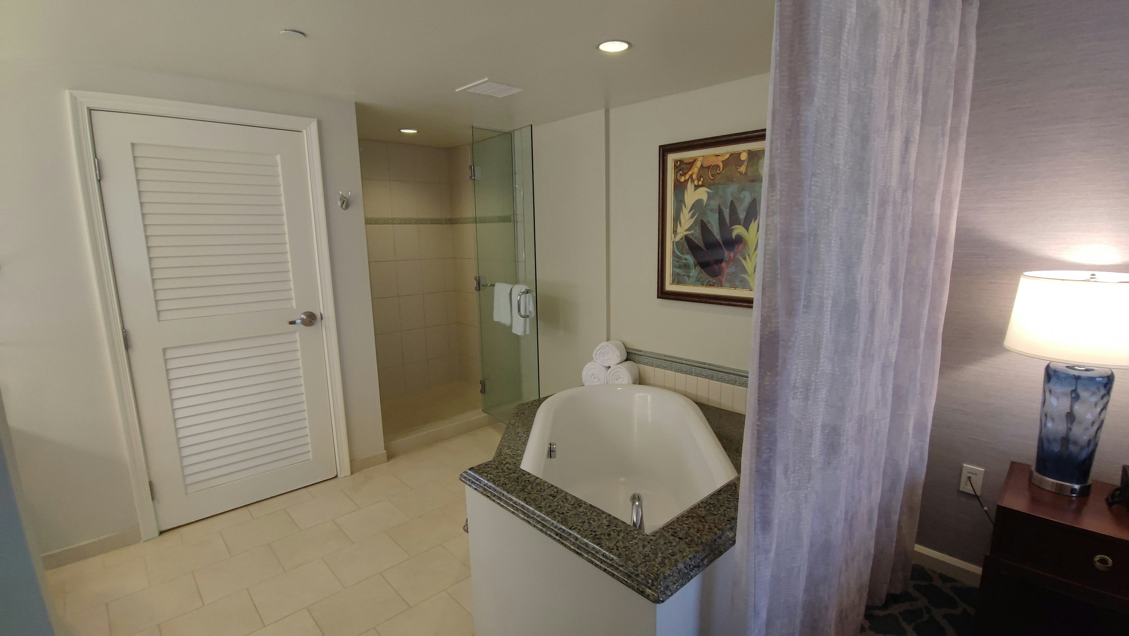 Modern bathroom interior featuring a bathtub and artwork