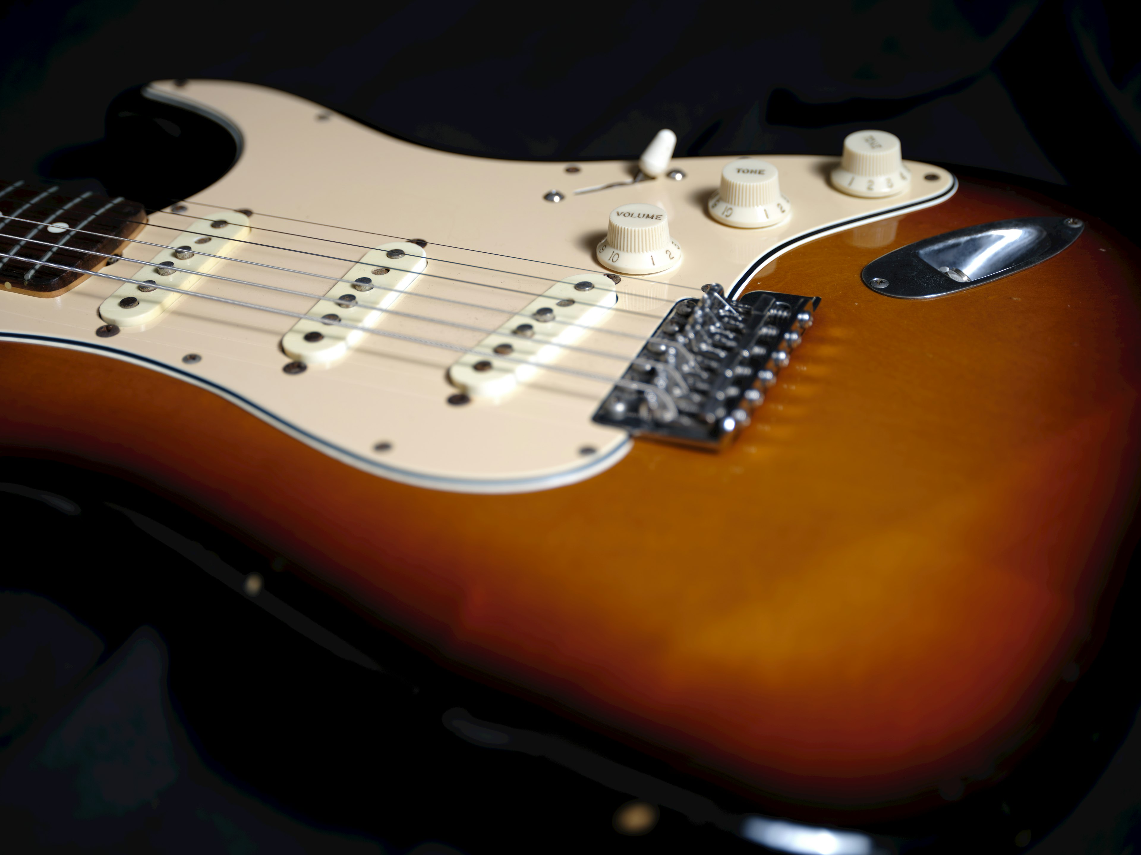 Close-up of an electric guitar body and pickups