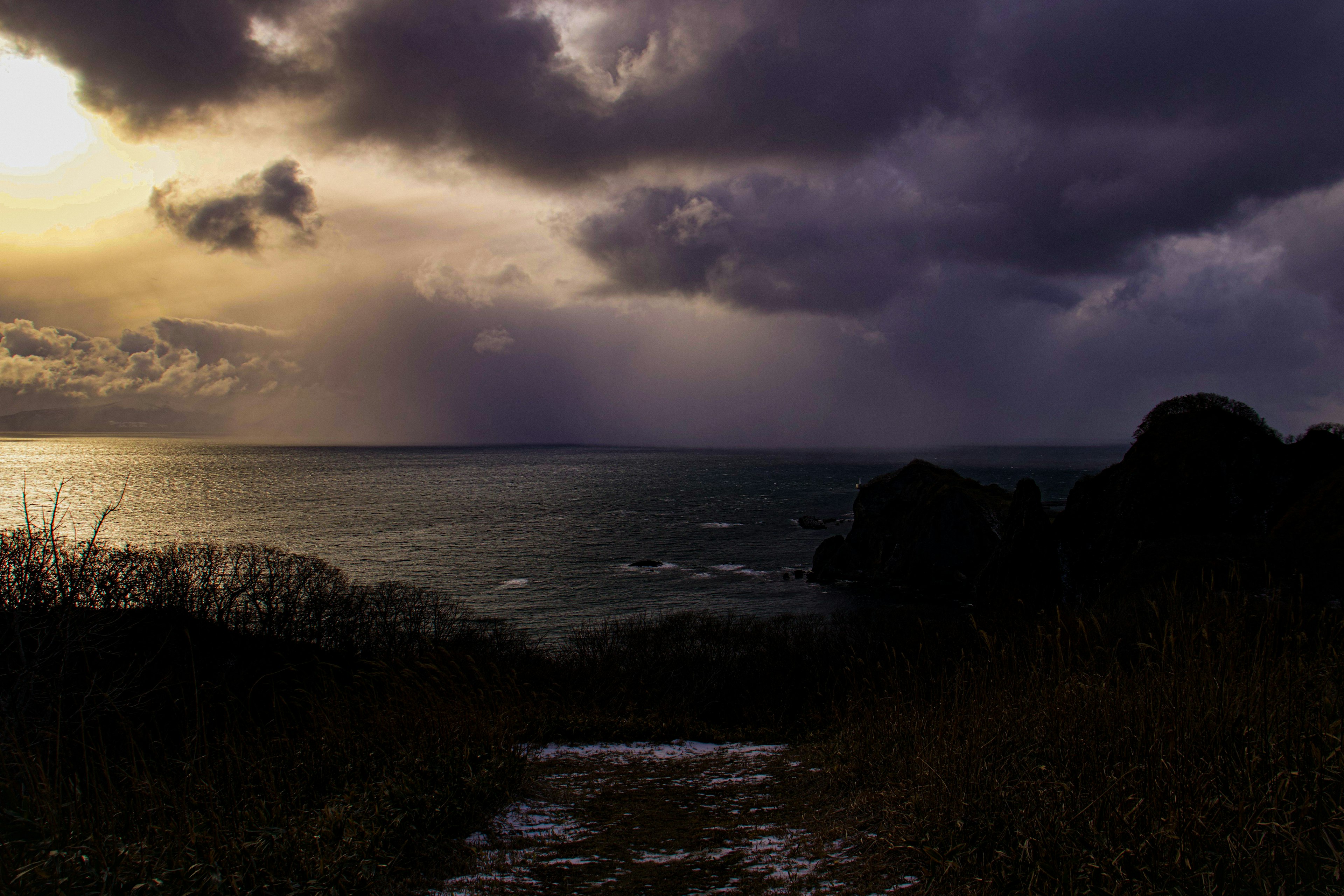 Twilight scene of the ocean with dramatic clouds