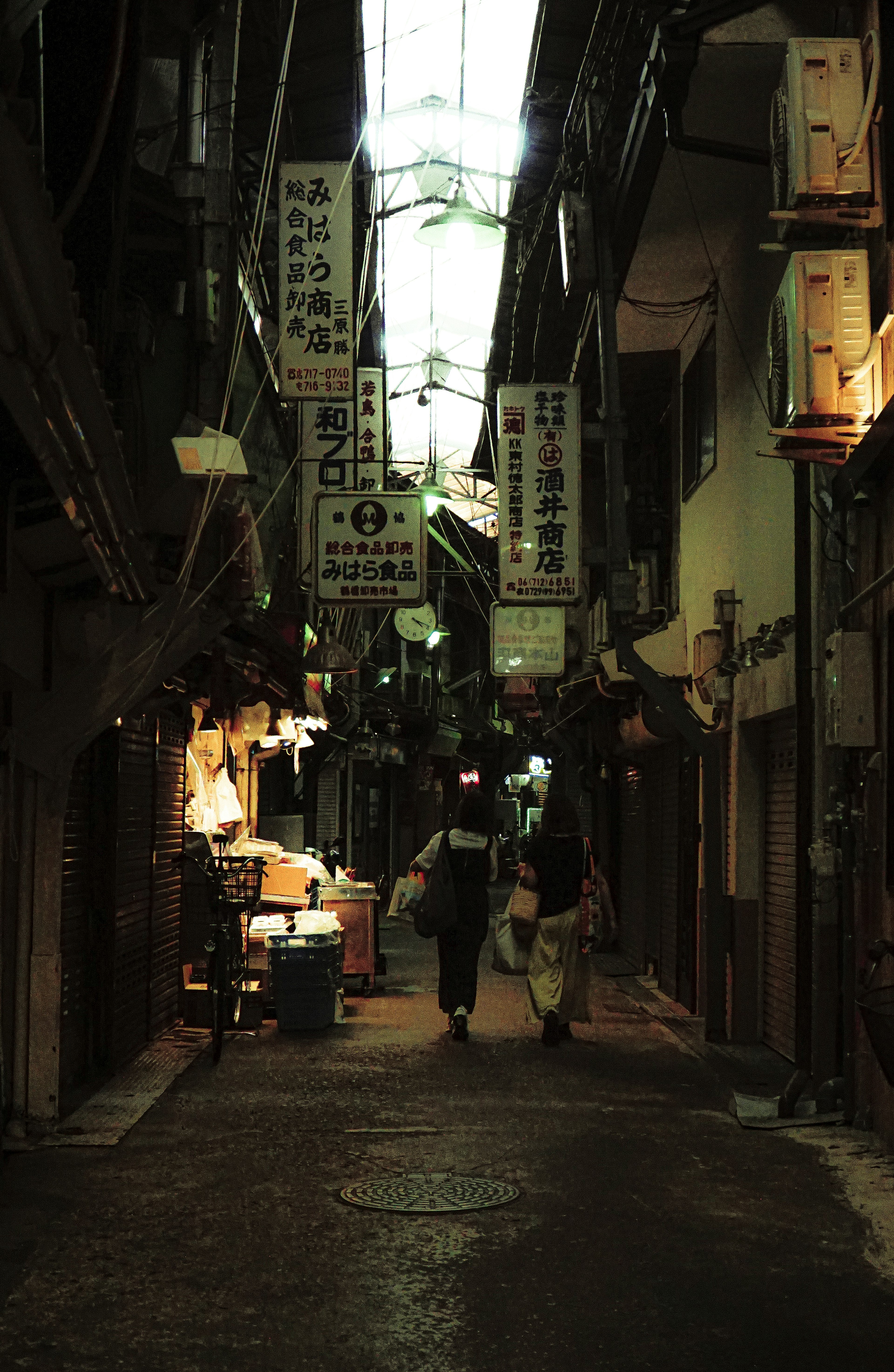 Dark alley with people walking unique lighting and signs