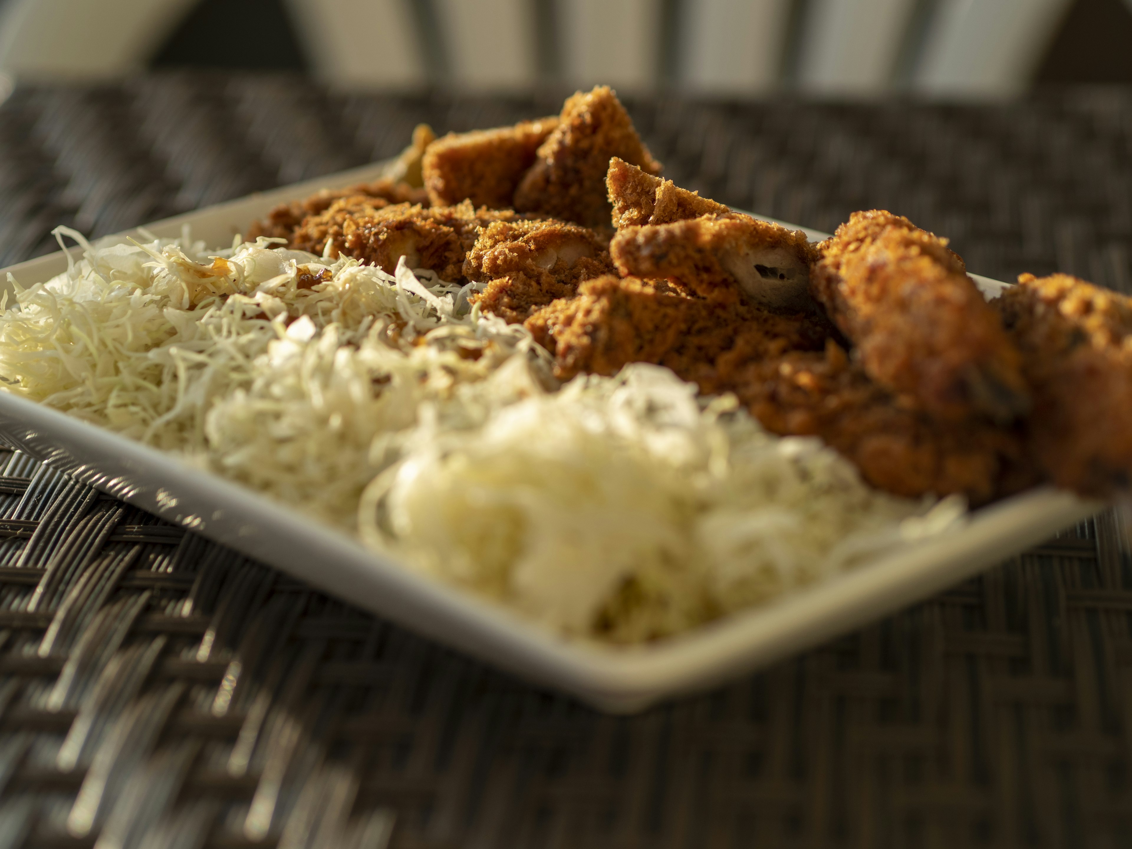 Plate of crispy fried chicken and shredded cabbage