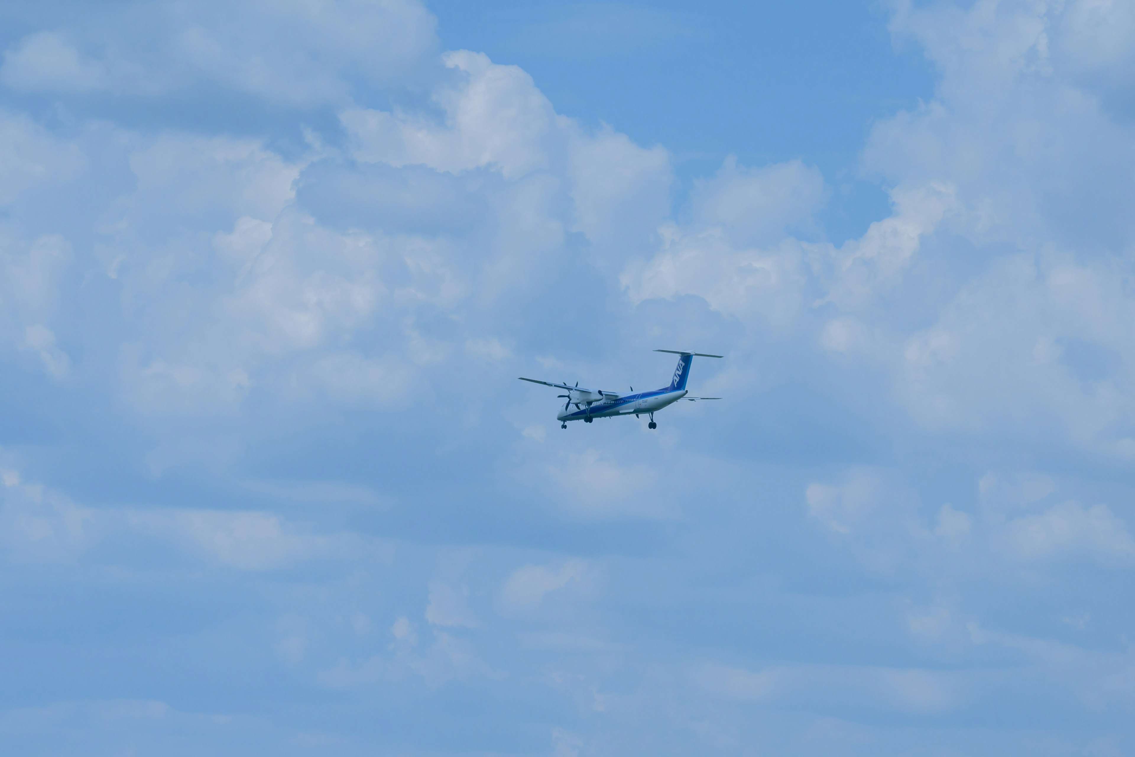 Small aircraft flying against a blue sky