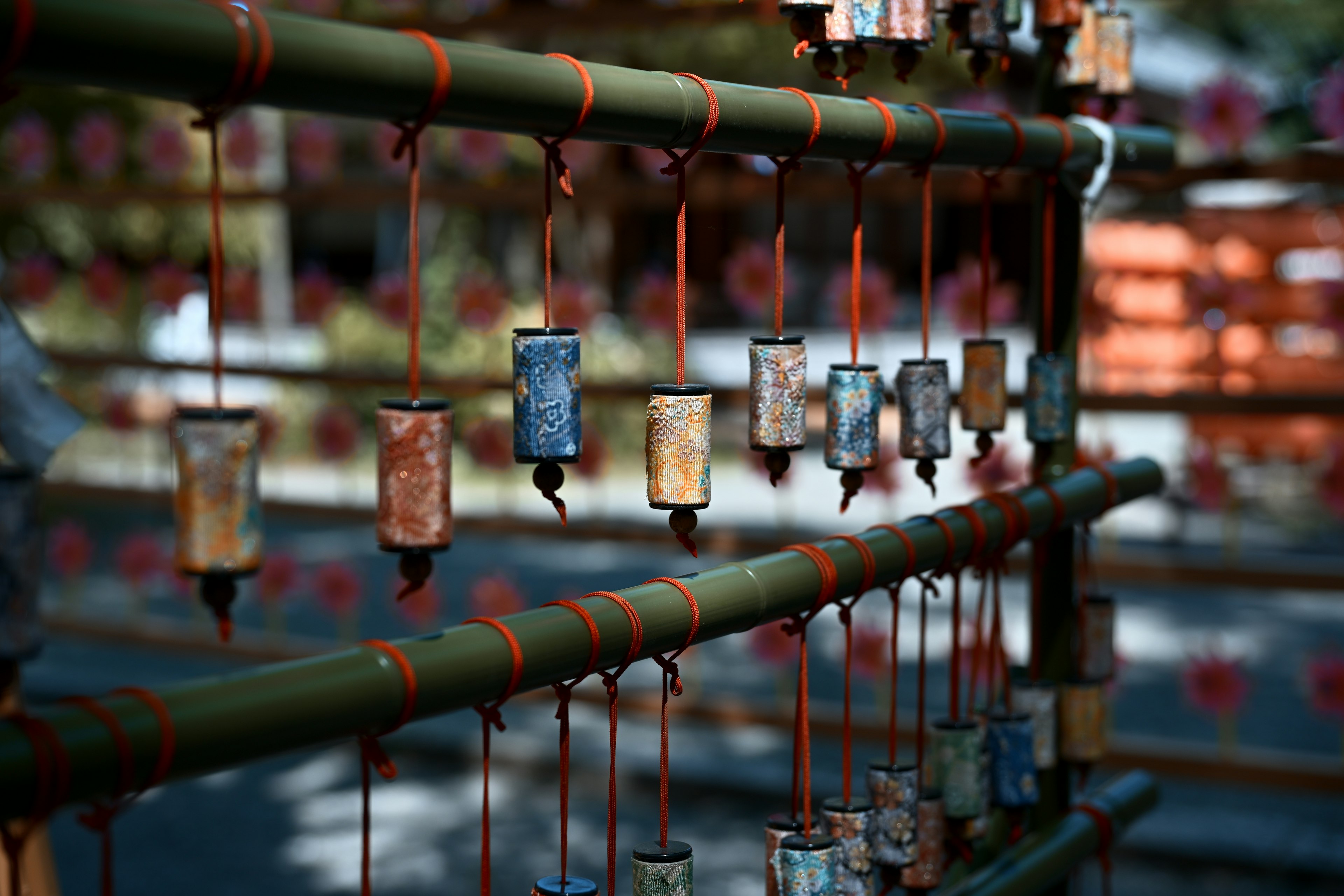 Colorful small bells hanging from a bamboo structure