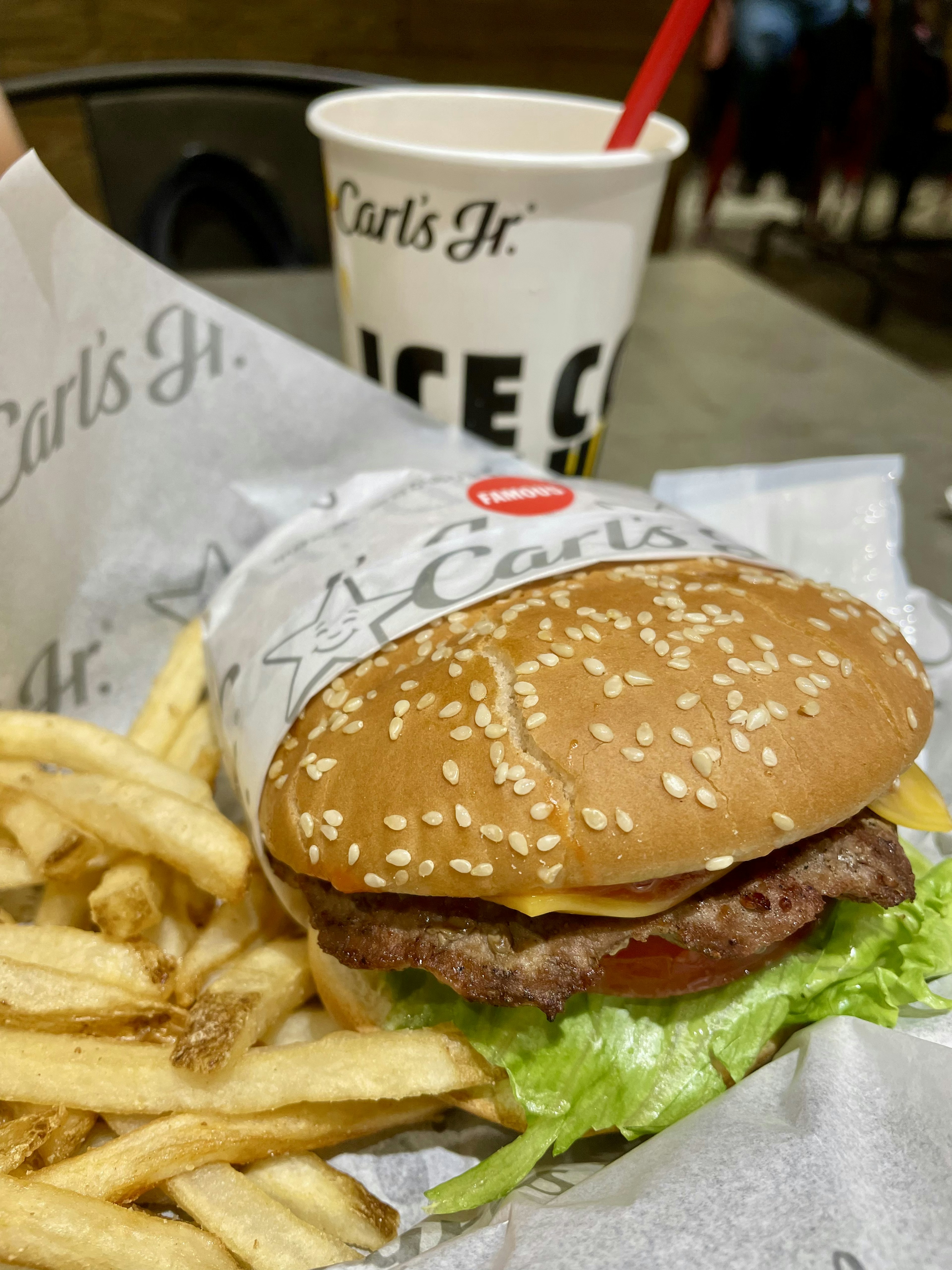 Un burger de Carl's Jr avec des frites et une boisson gazeuse