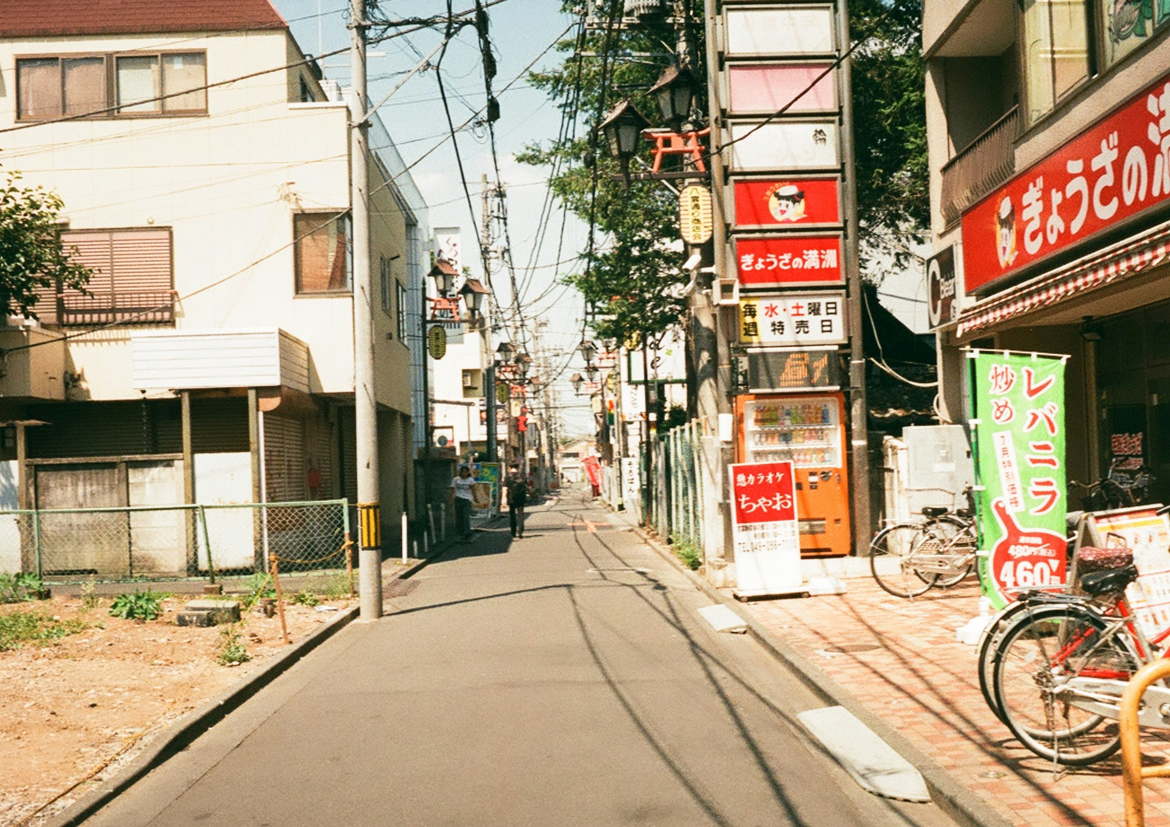 Narrow street lined with shops and houses