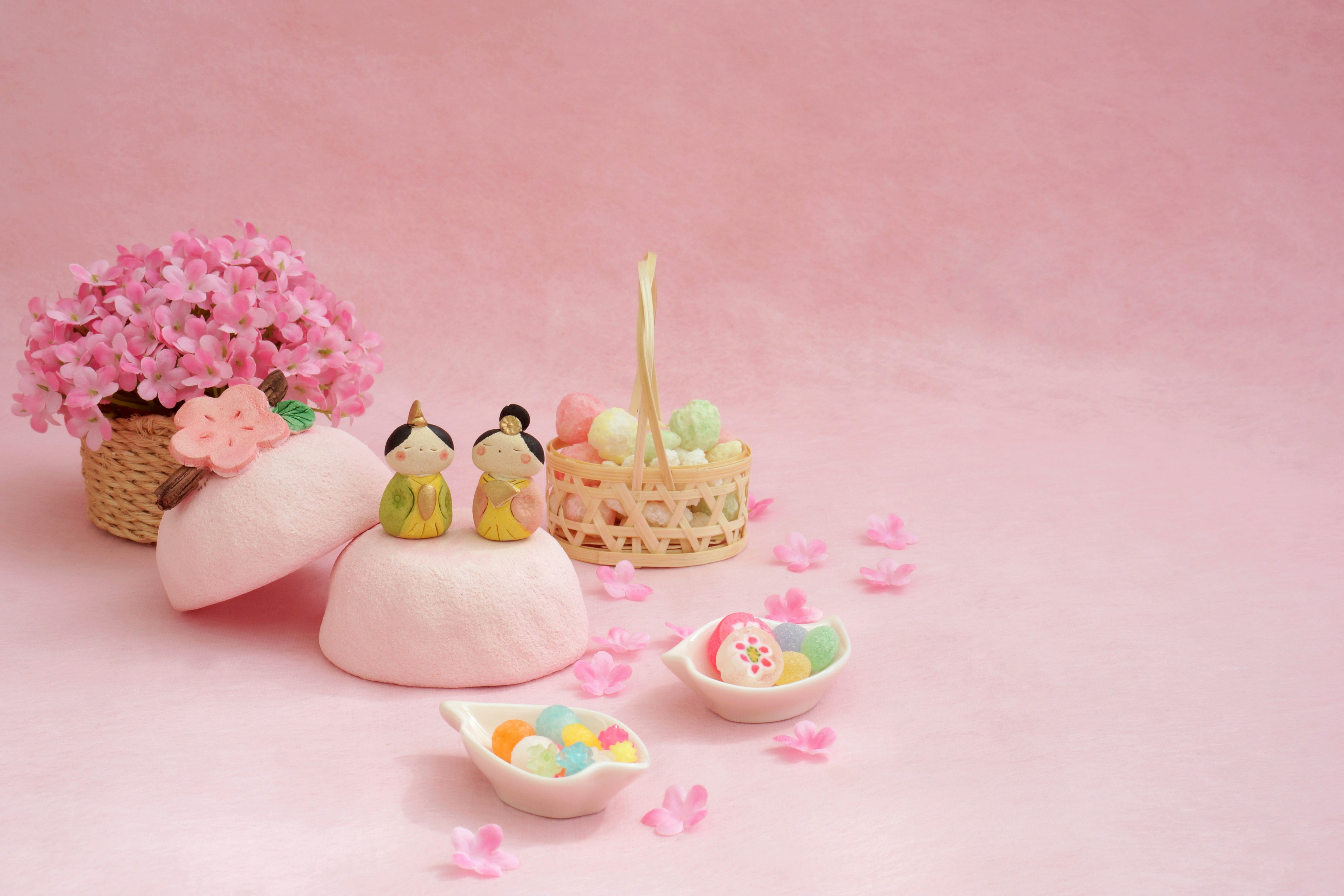 Scene featuring colorful sweets and flowers on a pink background