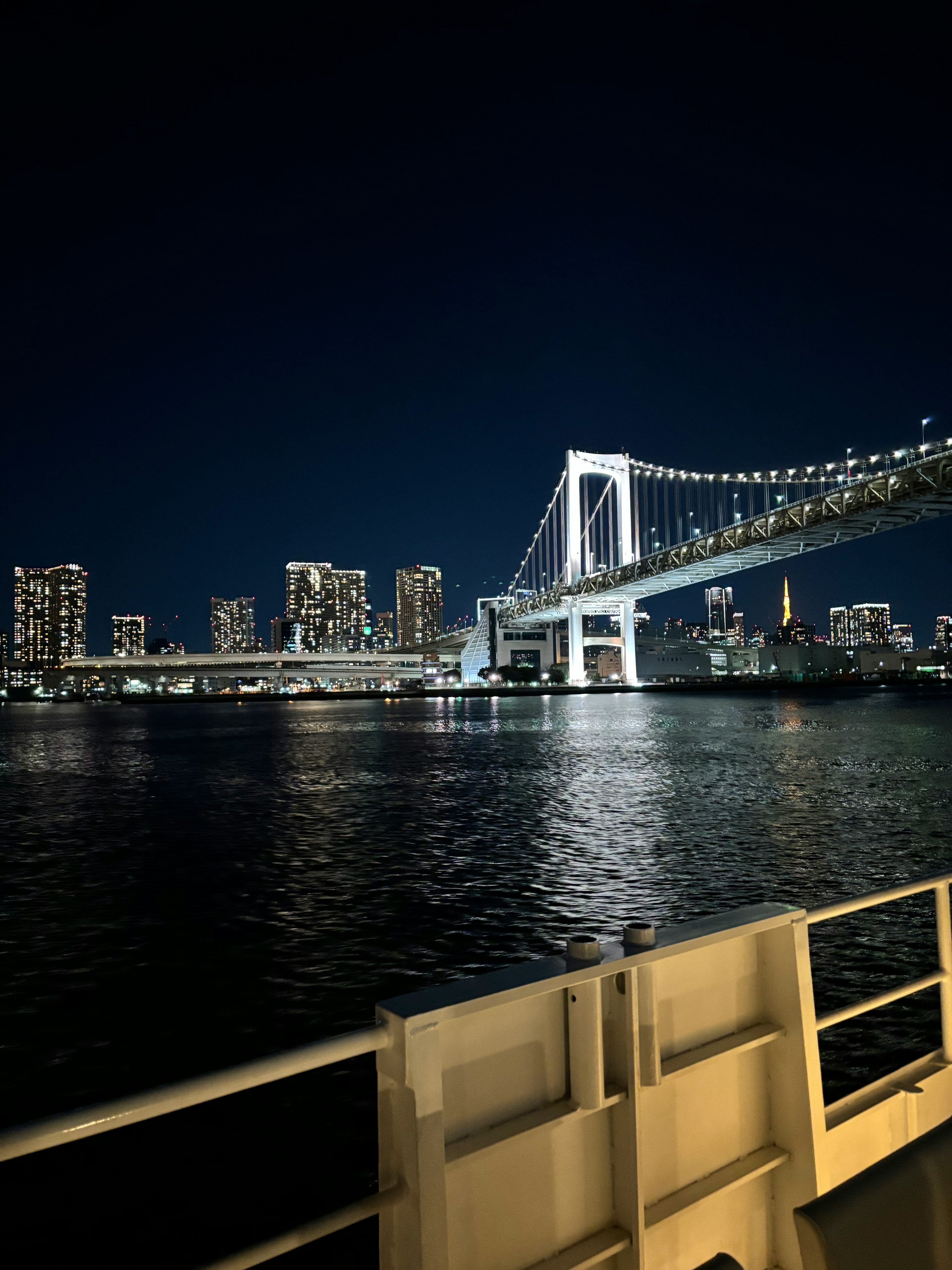 Beautiful night view of Rainbow Bridge and Tokyo skyline with illuminated buildings