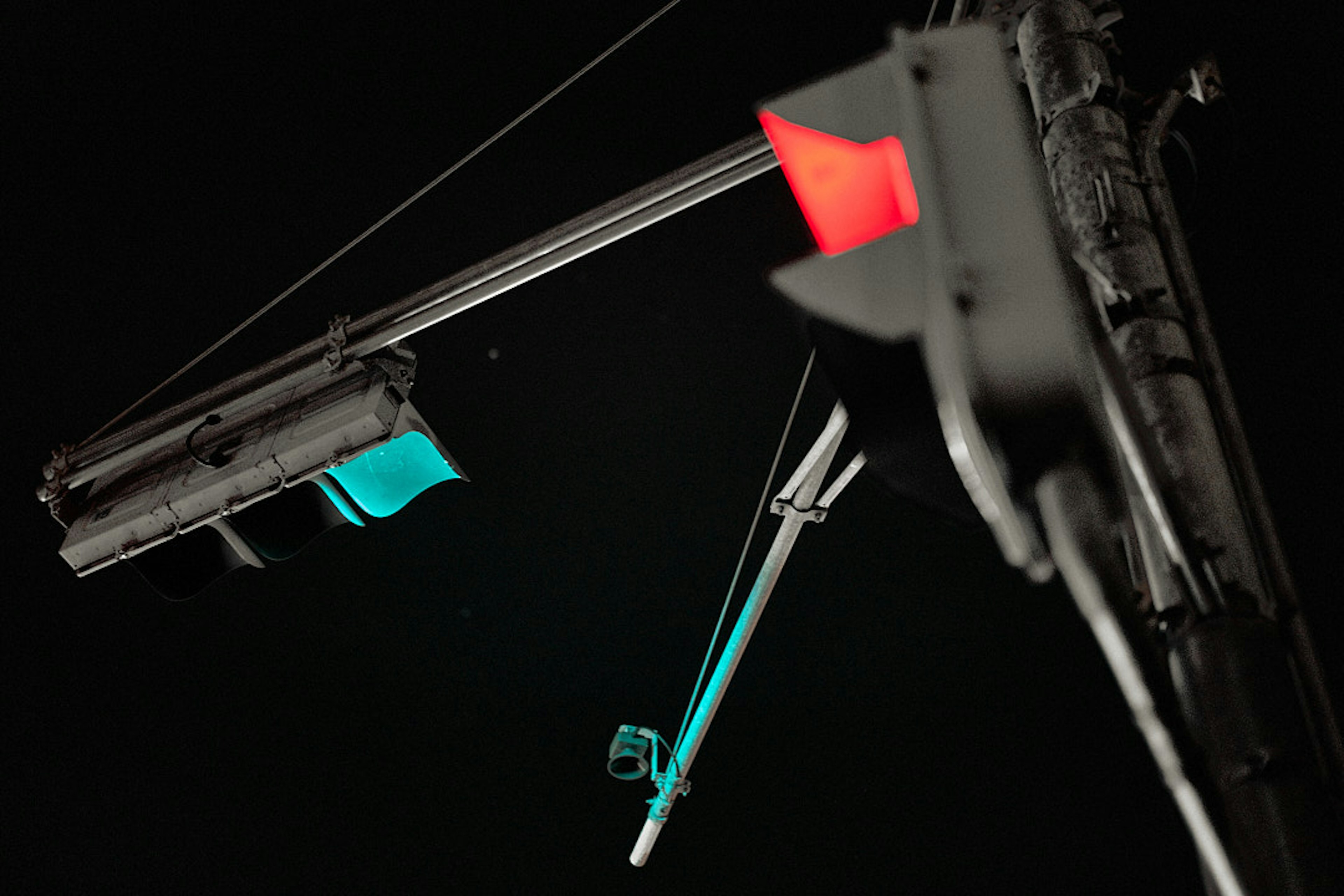 Traffic lights displaying red and green on a dark background