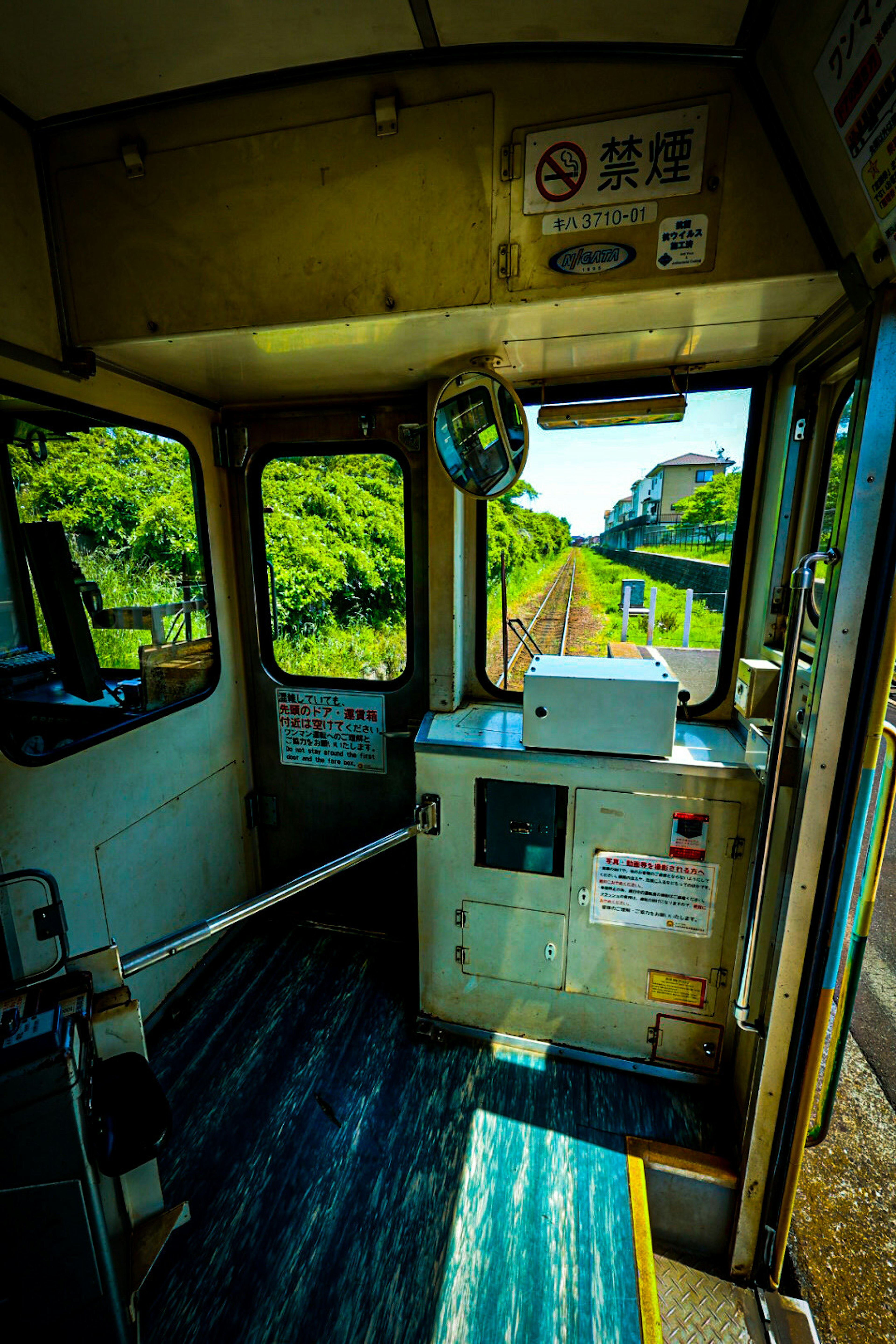 Interior view of a train driver's cabin showcasing controls and a scenic window