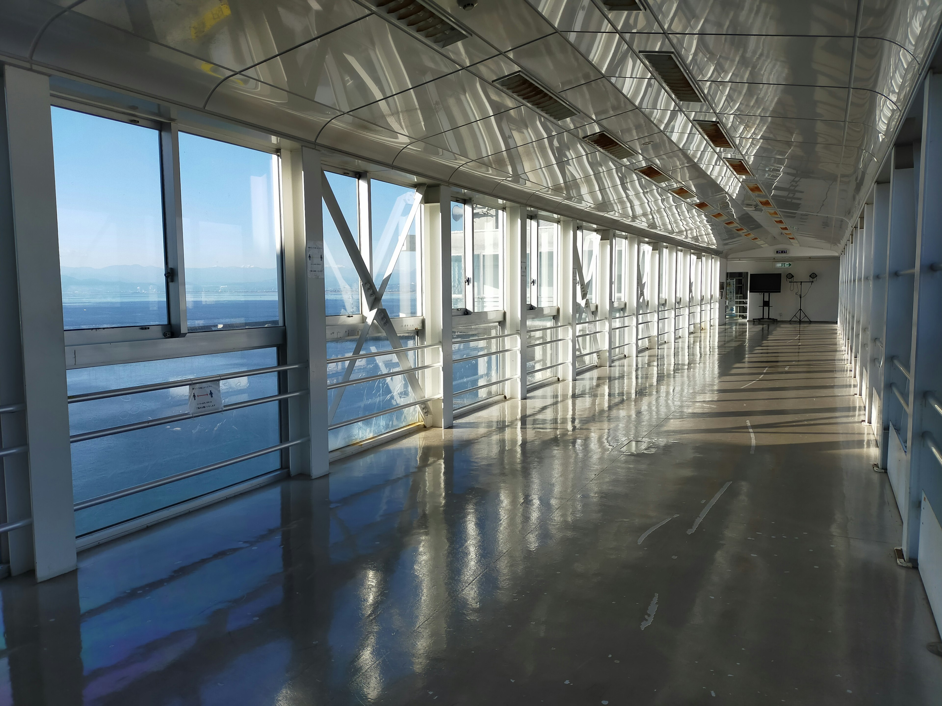 Bright glass corridor with ocean view