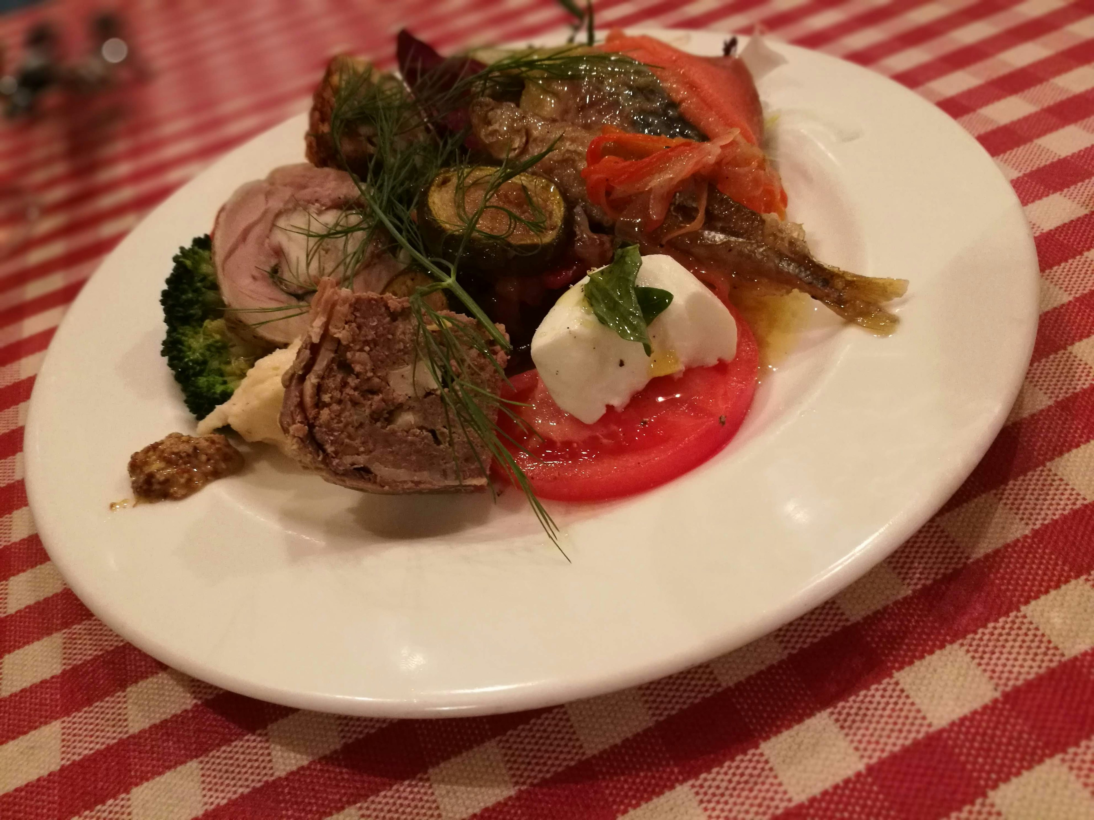 A colorful dish featuring a variety of vegetables and meats