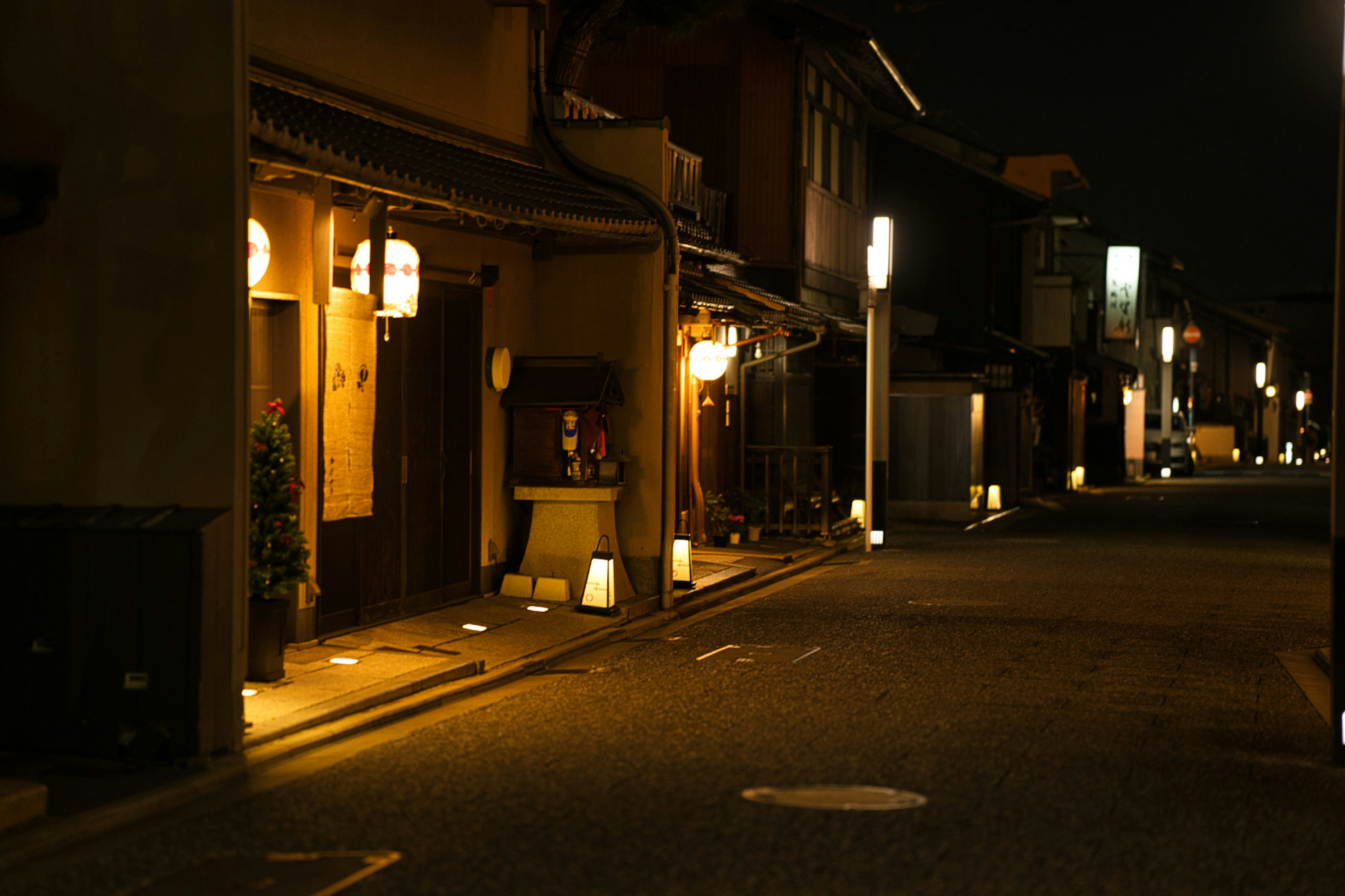 Quiet street scene at night with lanterns and traditional buildings