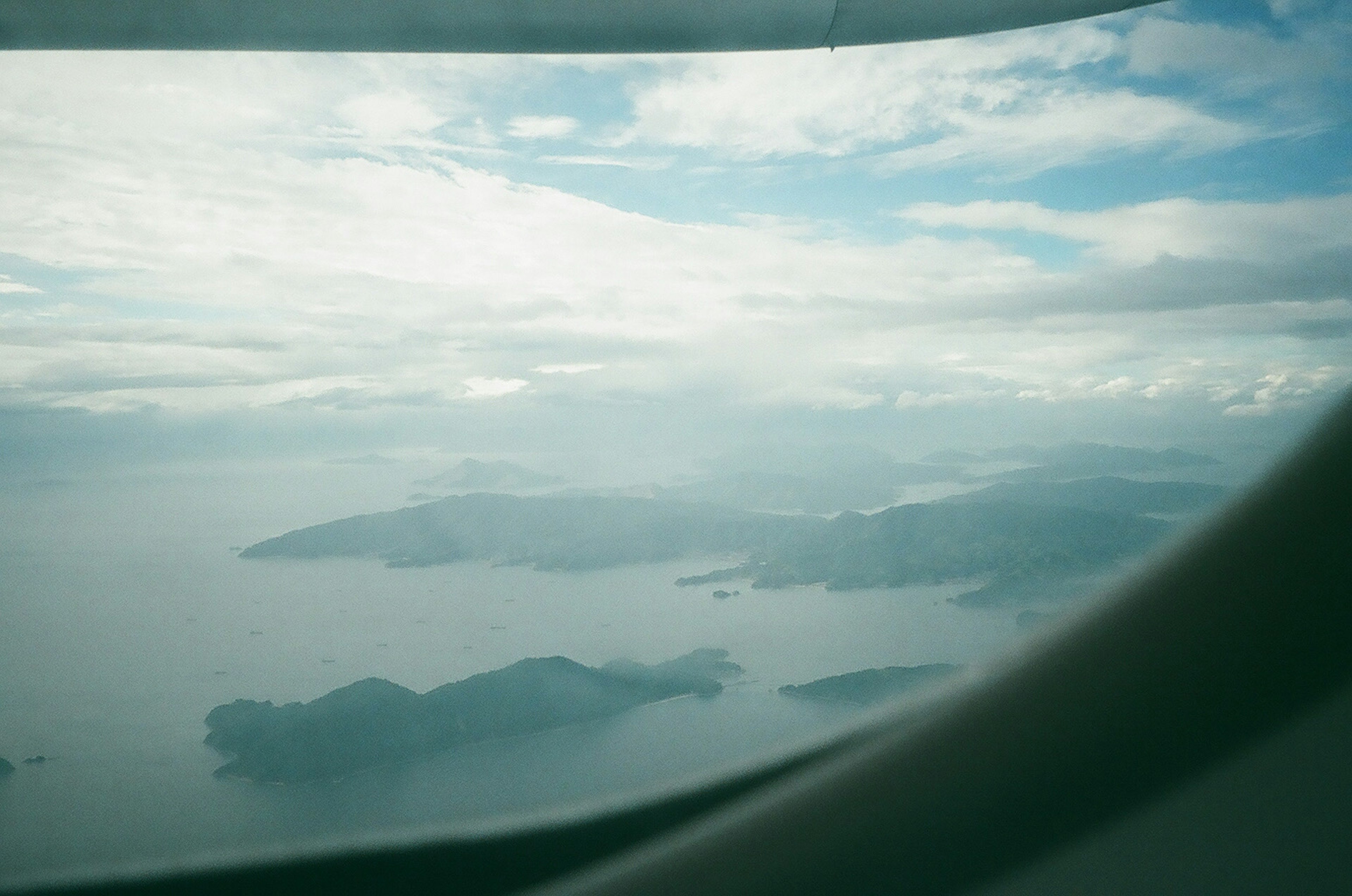 Aerial view of islands and ocean with drifting clouds