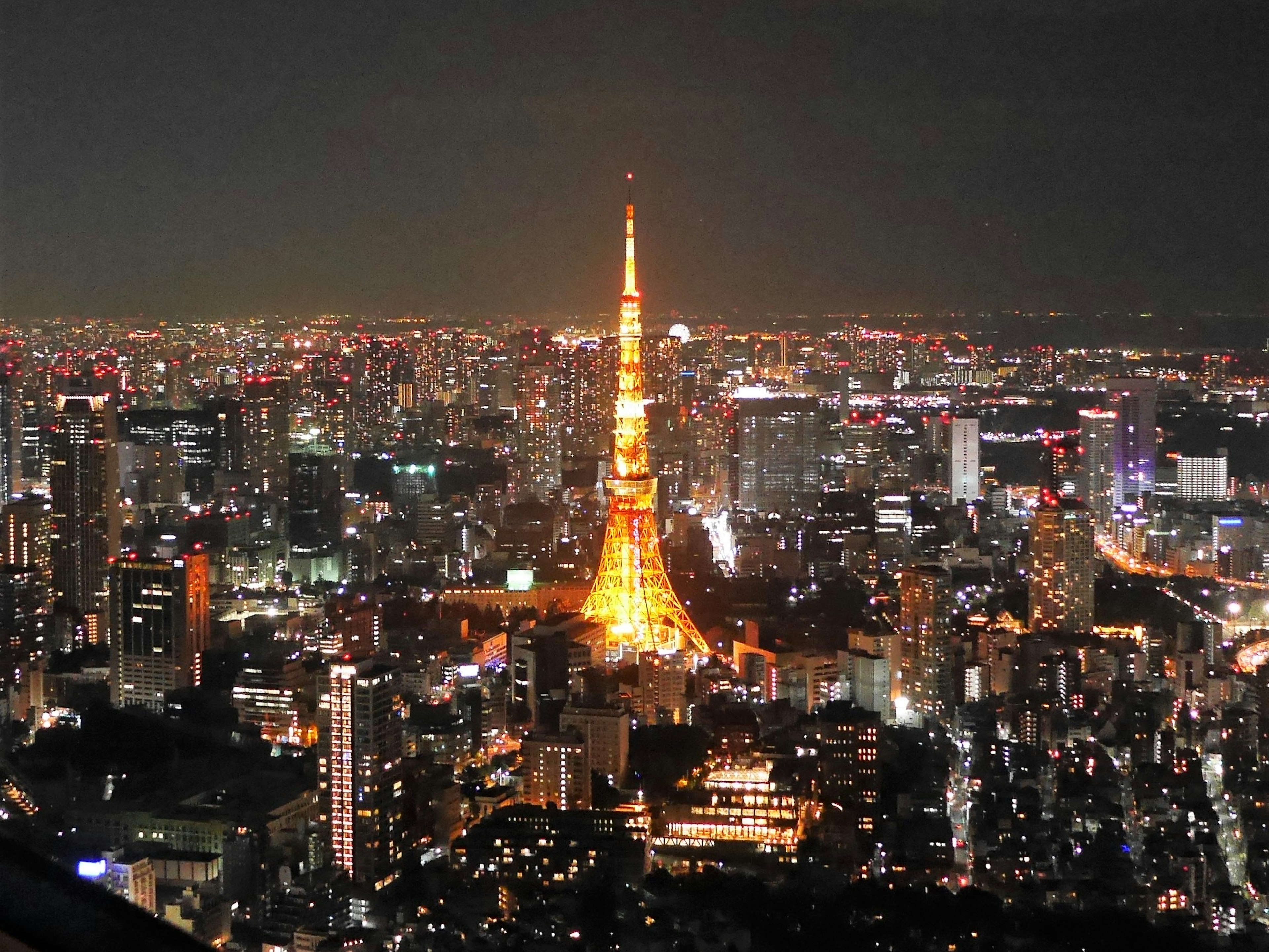 Tokyo Tower shining in a beautiful cityscape at night