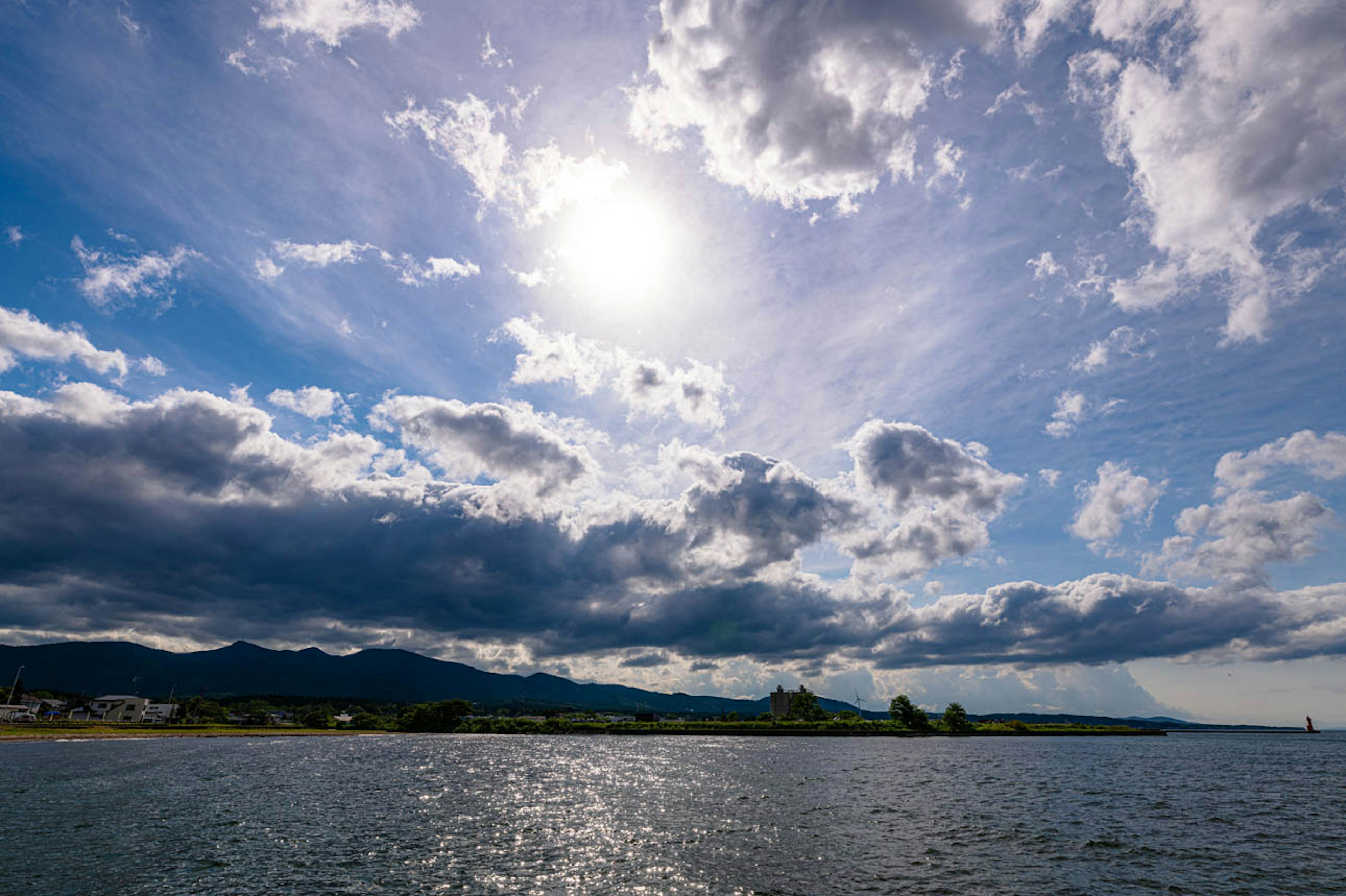 Scenic view of the ocean with blue sky and clouds Sun shining brightly